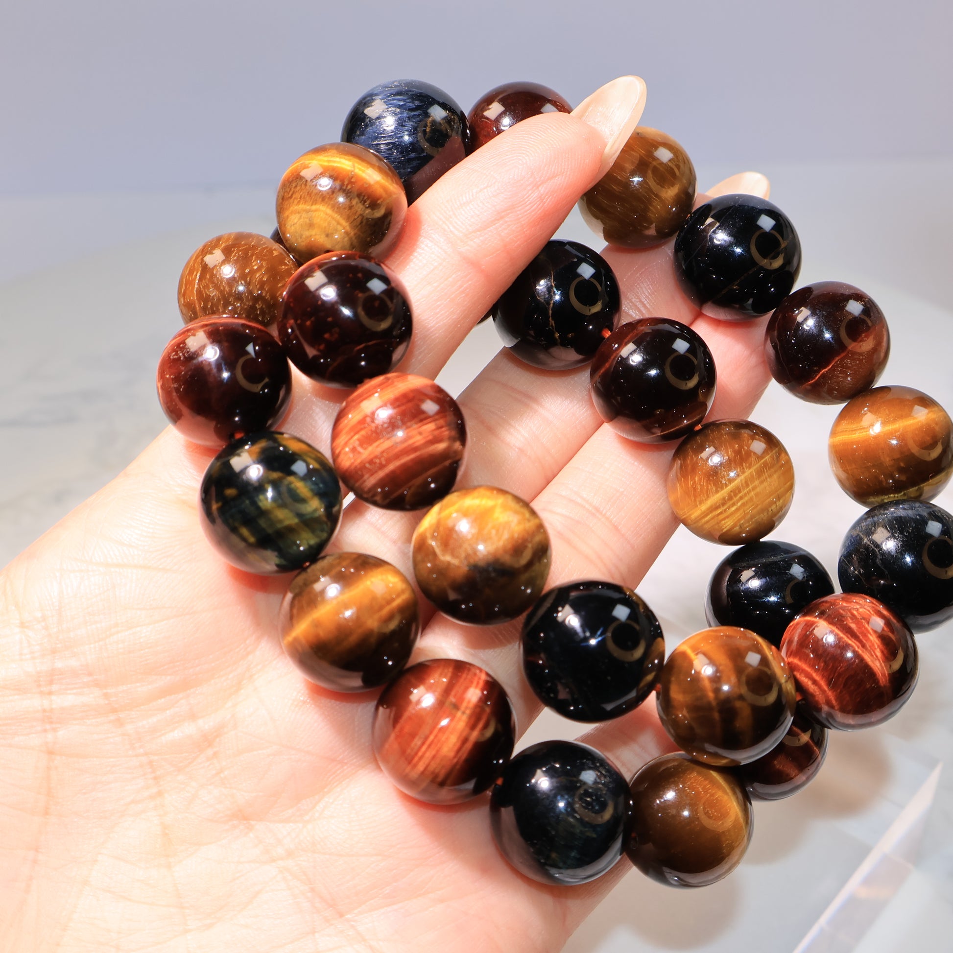 Group view of multiple Tiger Eye beads showing chatoyant lines.