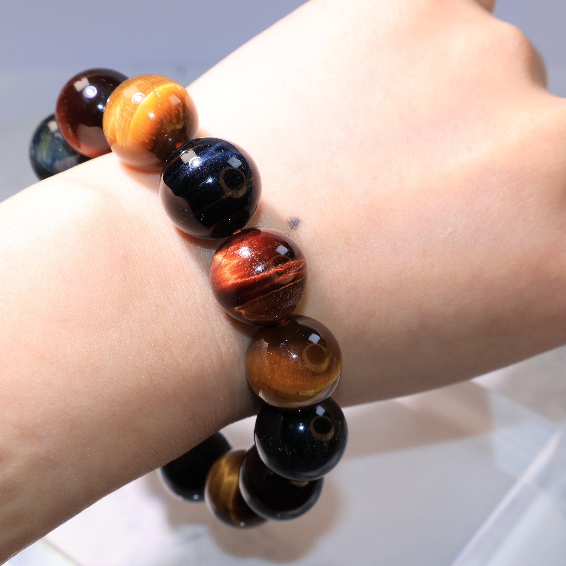 Bracelet worn on wrist showing the natural chatoyancy of the stones.