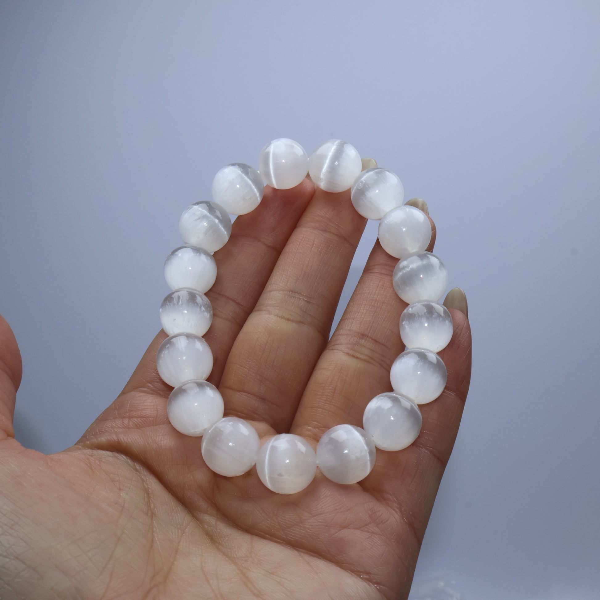 Handheld close-up of the bracelet showing the soft moonlight-like sheen