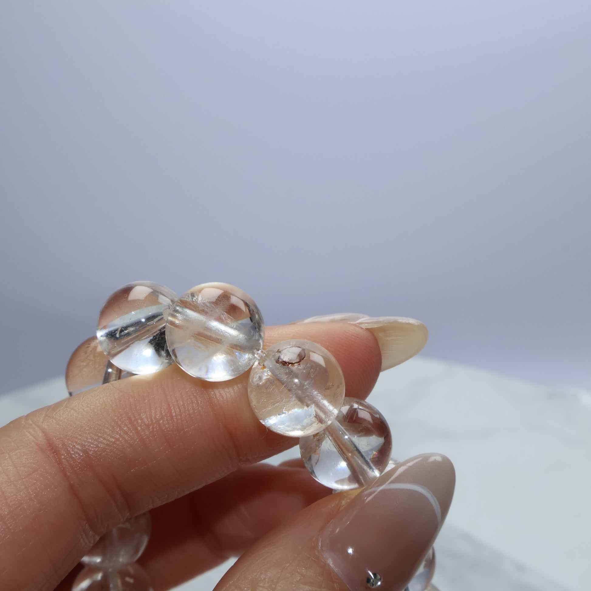 Detail shot of clear quartz beads revealing internal textures and natural marks