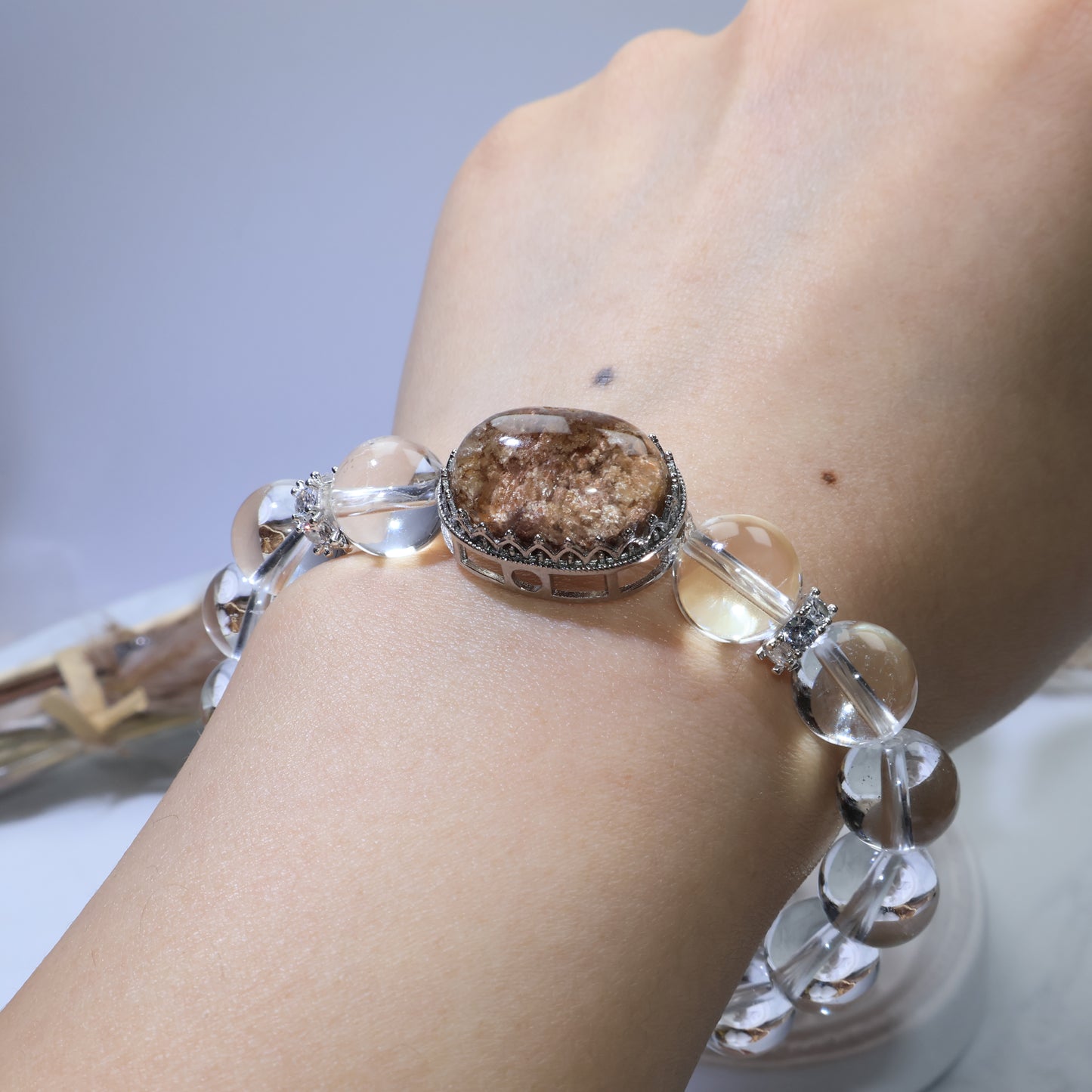 Full wrist view of Phantom Quartz bracelet showing symmetrical bead arrangement and centerpiece position