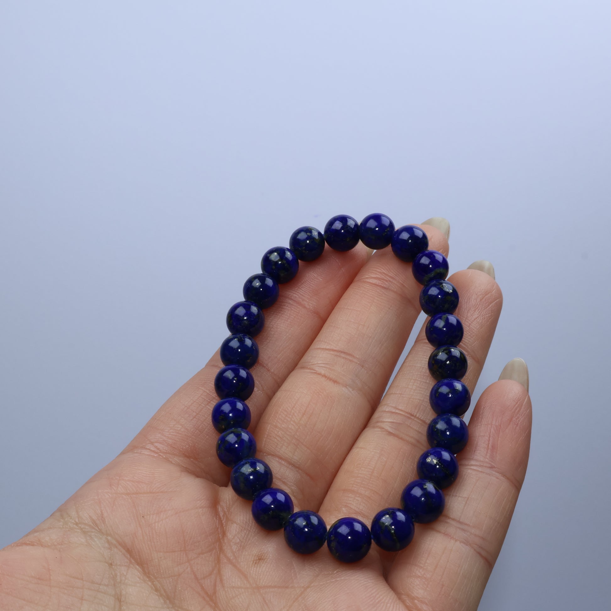 Handheld view of bracelet highlighting its uniform polish and clarity