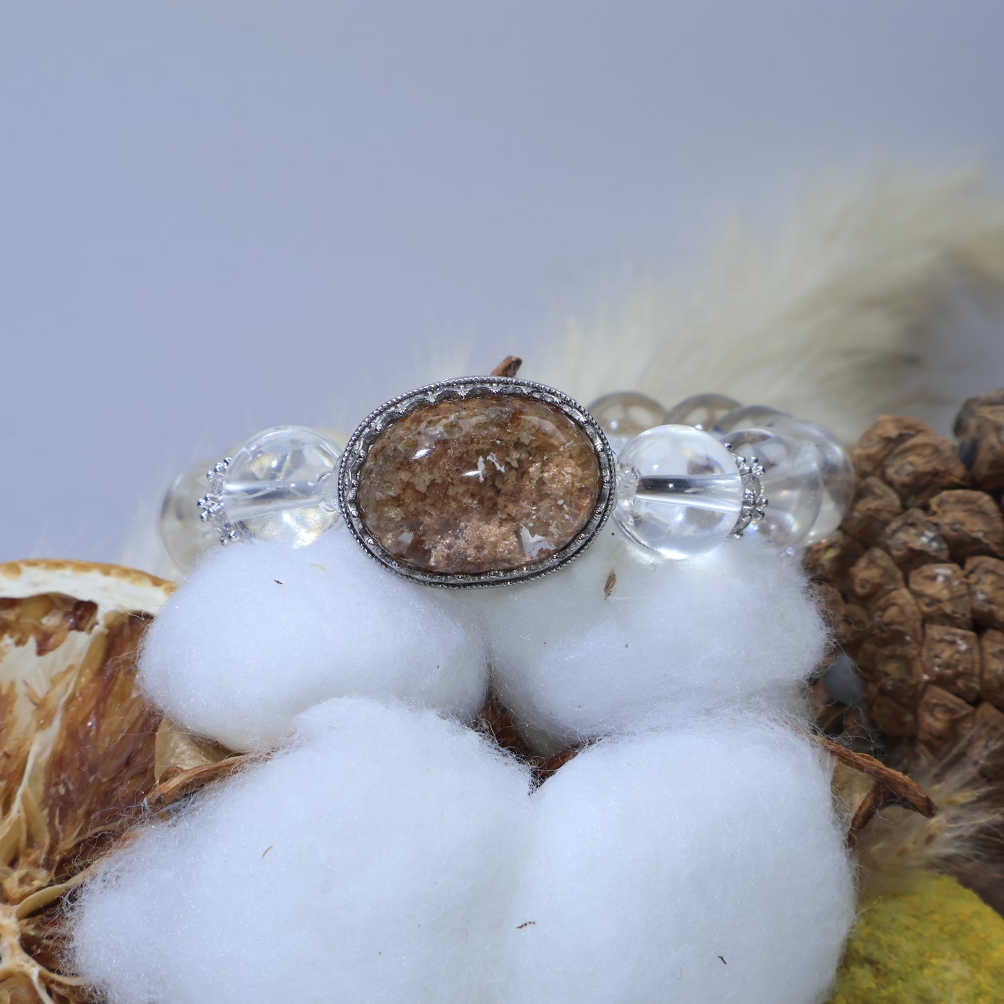 Front angle of Phantom Quartz cabochon centerpiece resting on white cotton decoration