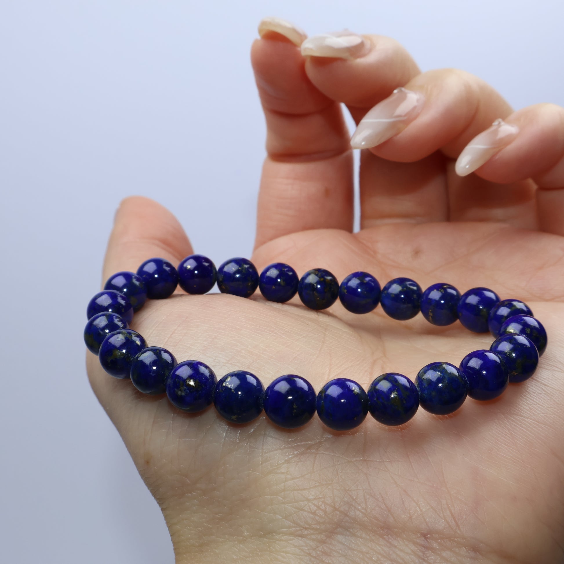 Palm shot with bracelet loosely displayed for shape and color detail