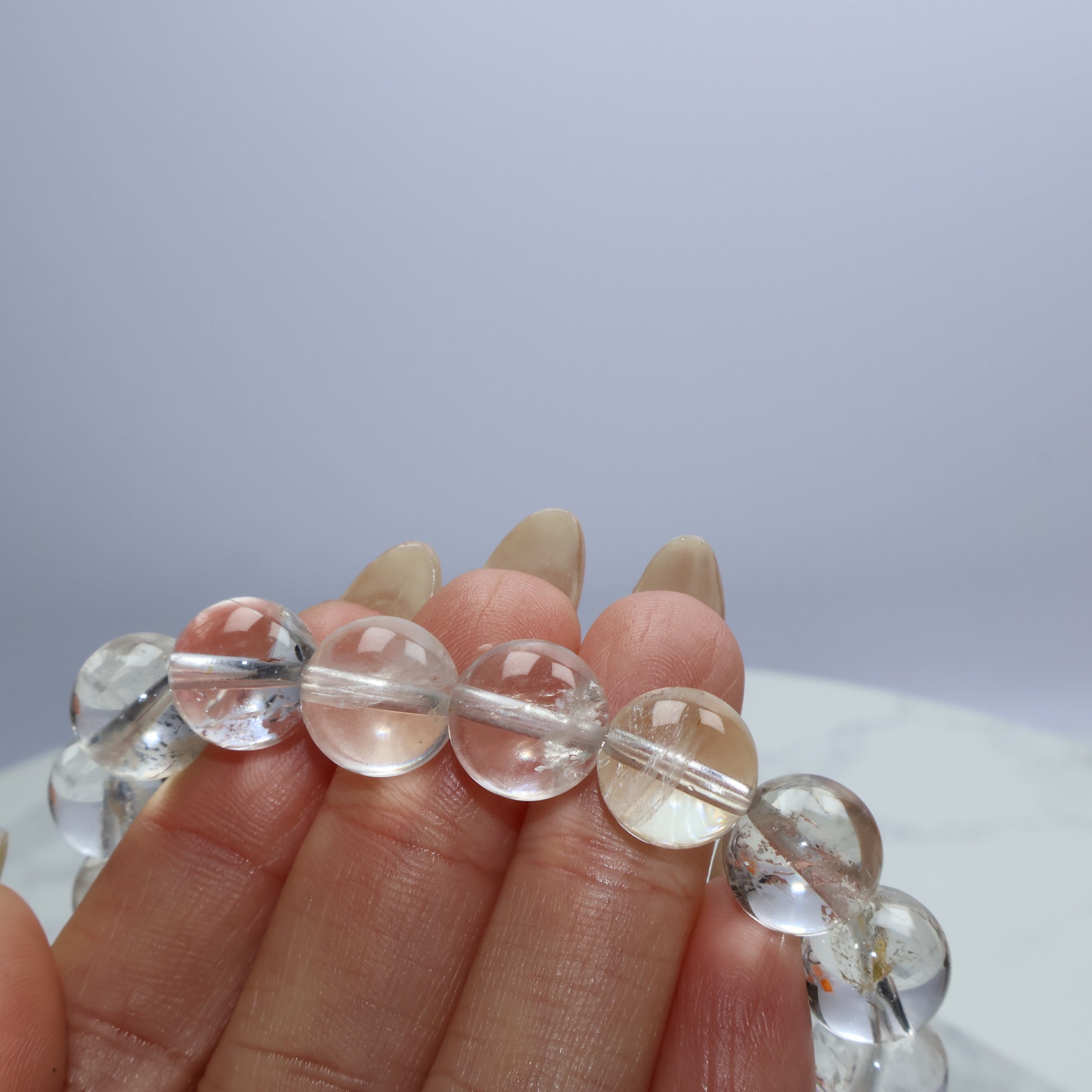 Detail shot of clear quartz beads revealing internal textures and natural marks