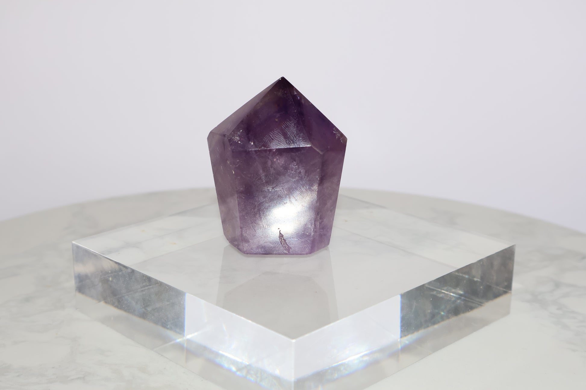 Standing amethyst crystal tower on clear acrylic base – front view