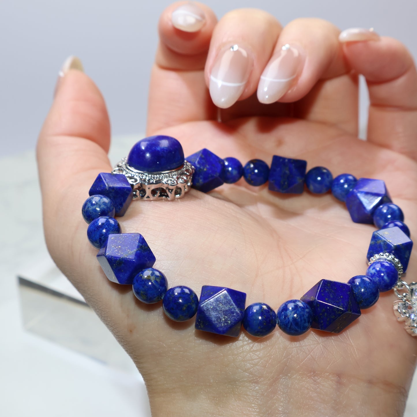 Close-up of Lapis Lazuli bracelet worn on wrist showing blue depth and brass setting