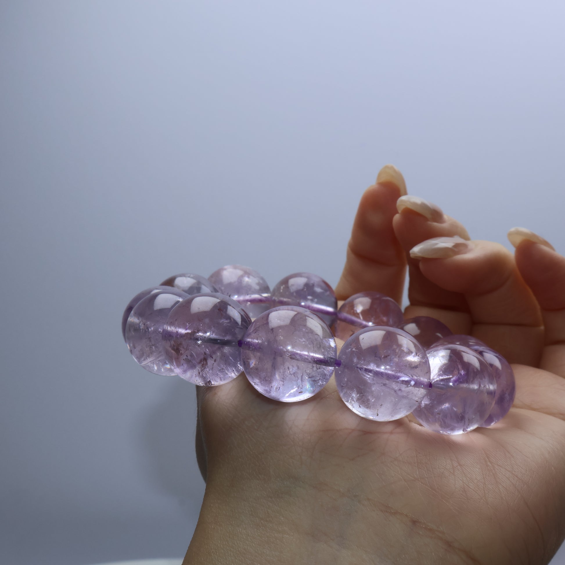 Side angle showing natural inclusions inside matte-look amethyst beads