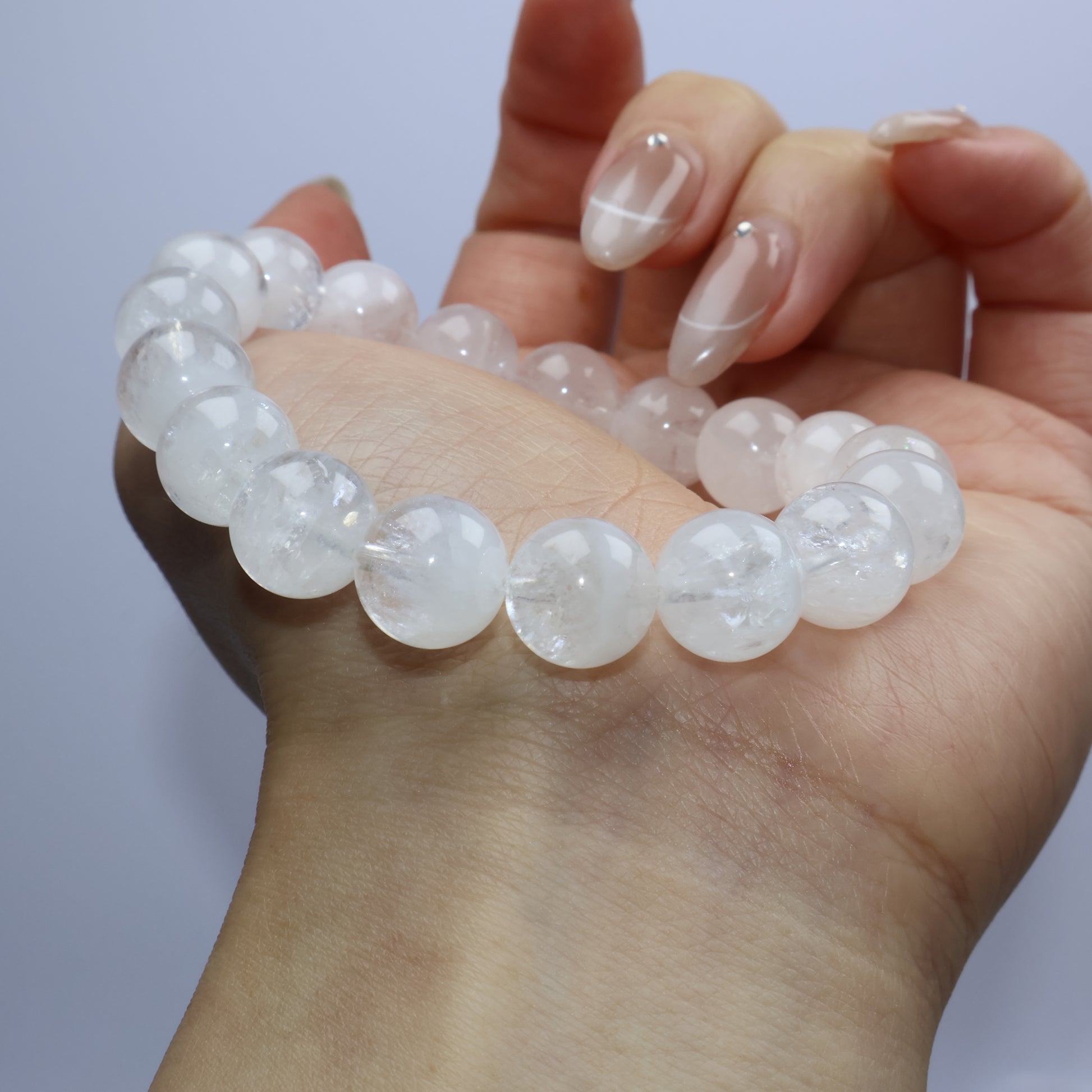 Side angle of bracelet across the palm showing soft light and clarity