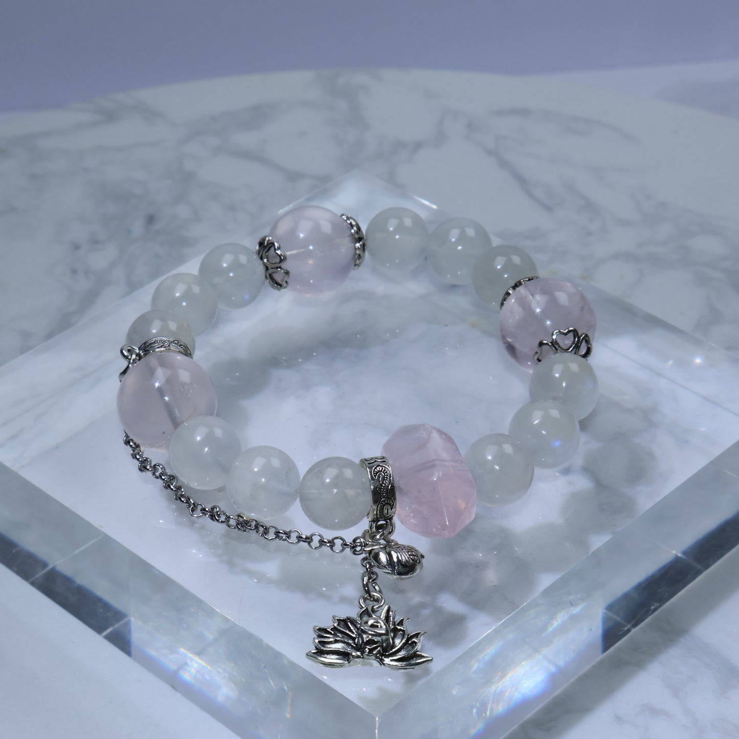 Flat lay of Mystic Key original bracelet with 福 peach charm