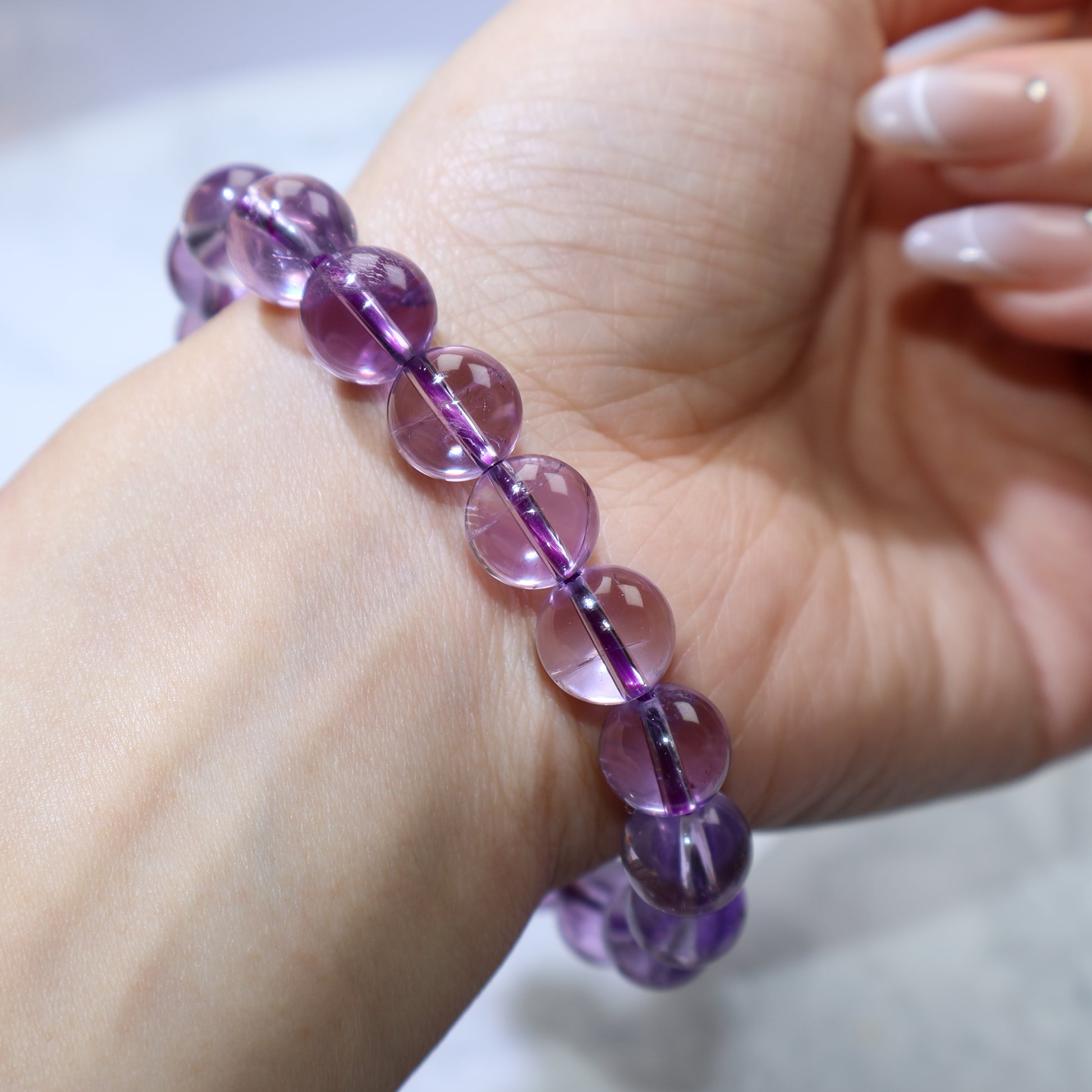 Wrist view showing full circle of high-clarity amethyst beads