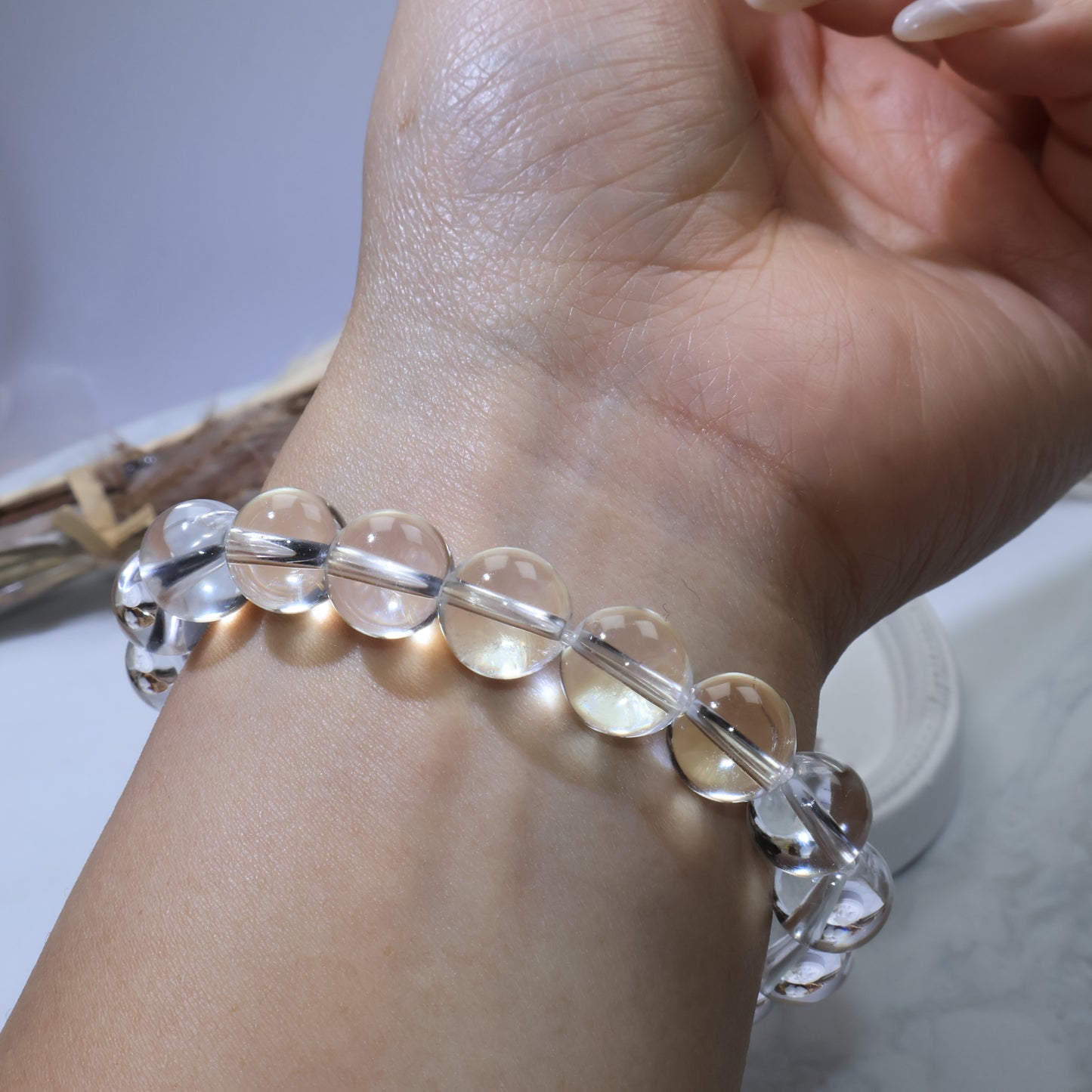 Close-up of bracelet beads reflecting light, emphasizing polished surface and high transparency
