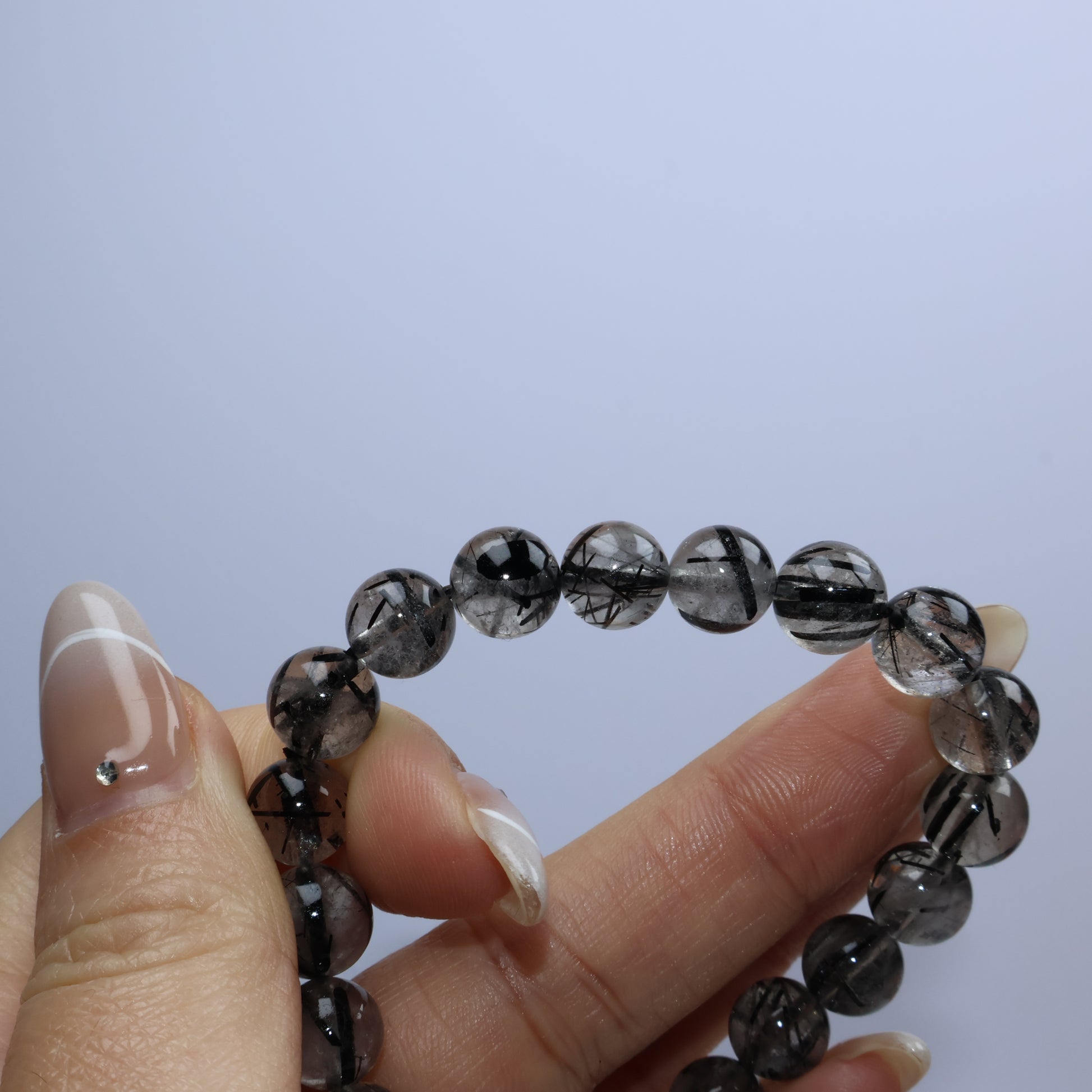 Side hold with bracelet bent, highlighting the internal rutile structure