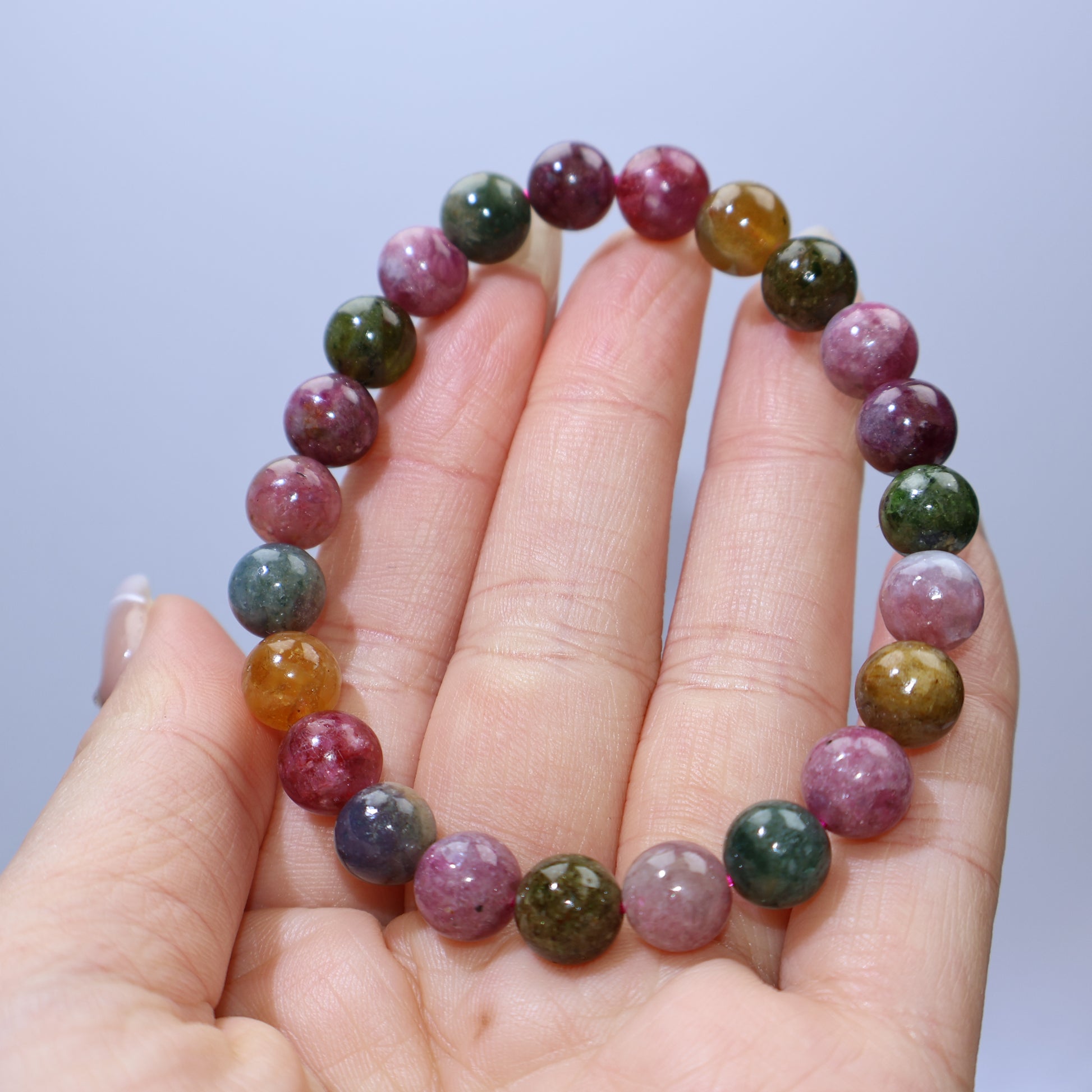 Close-up of 8mm tourmaline beads highlighting natural inclusions and bright hues