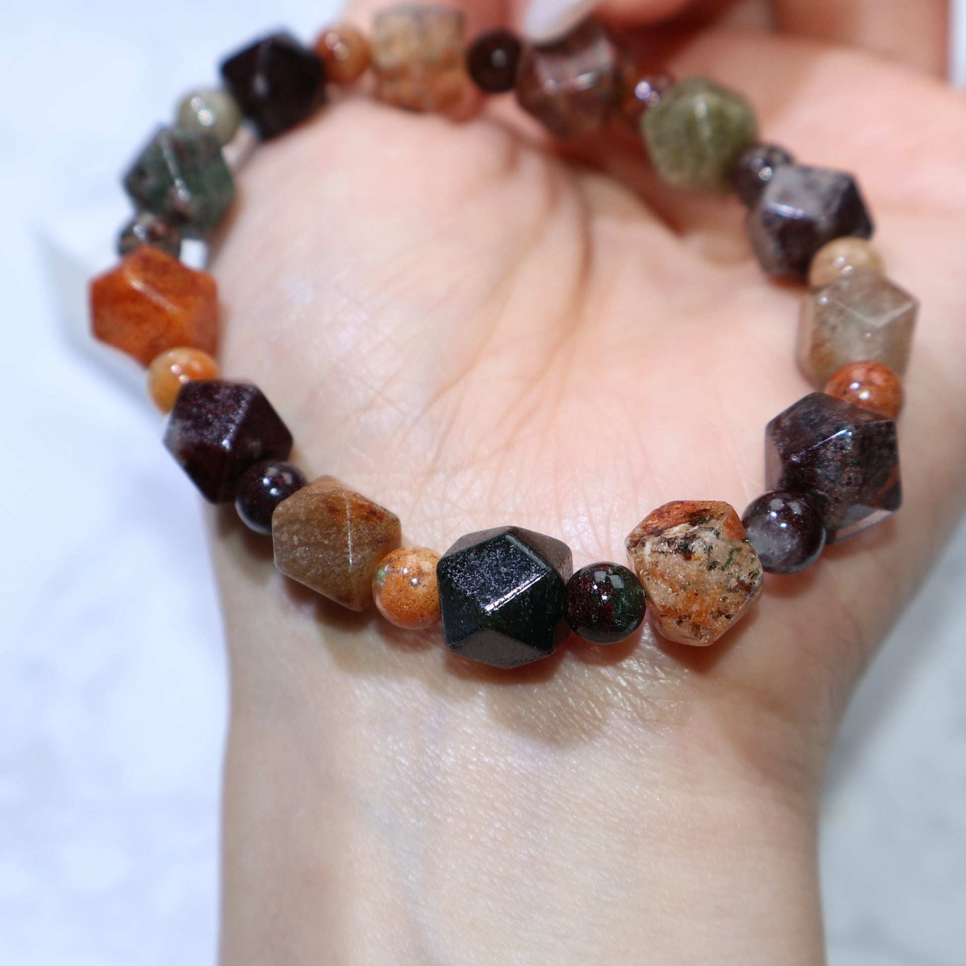 Bracelet resting on white background showing bead shape and size