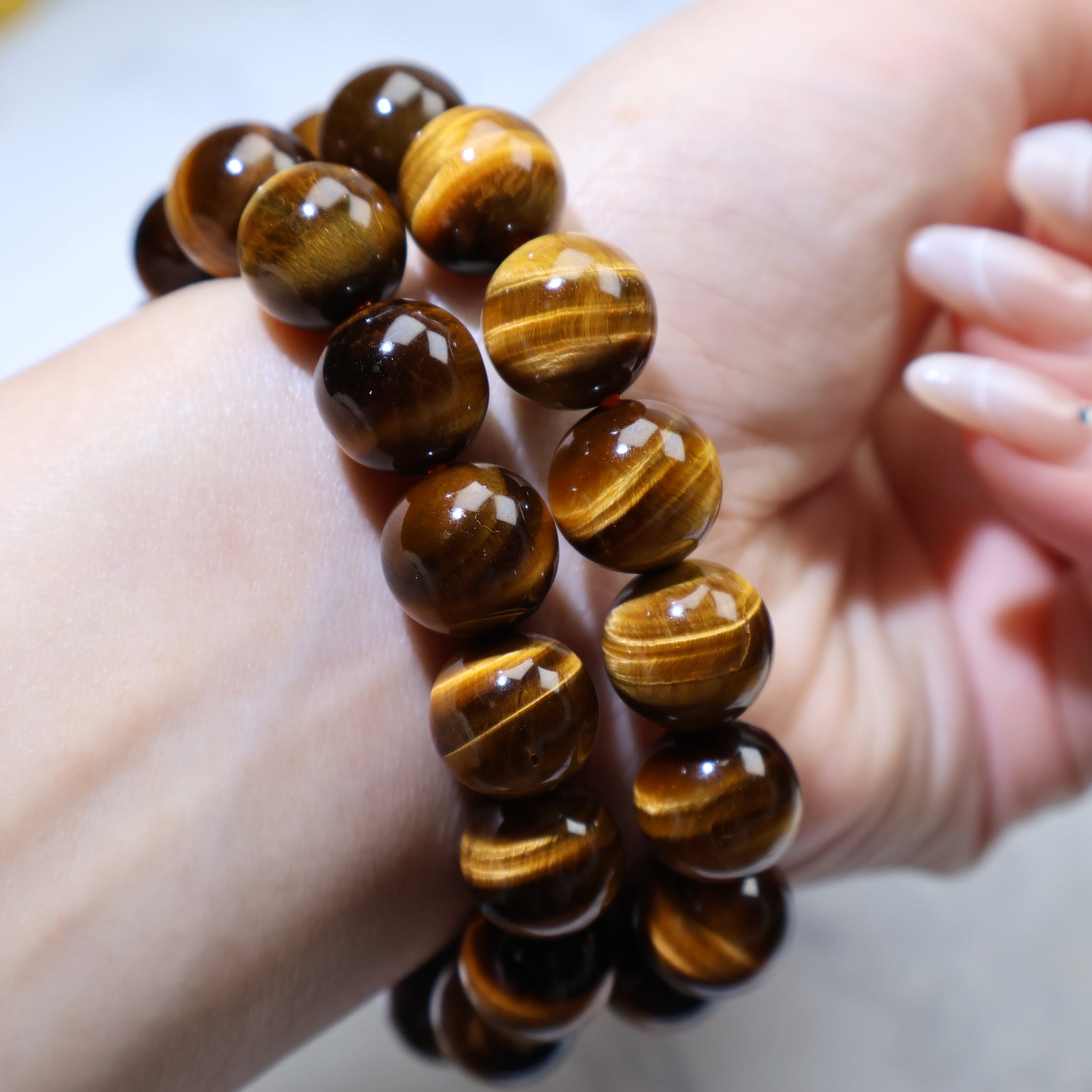 Close-up of stacked bracelets focusing on chatoyance and bead texture