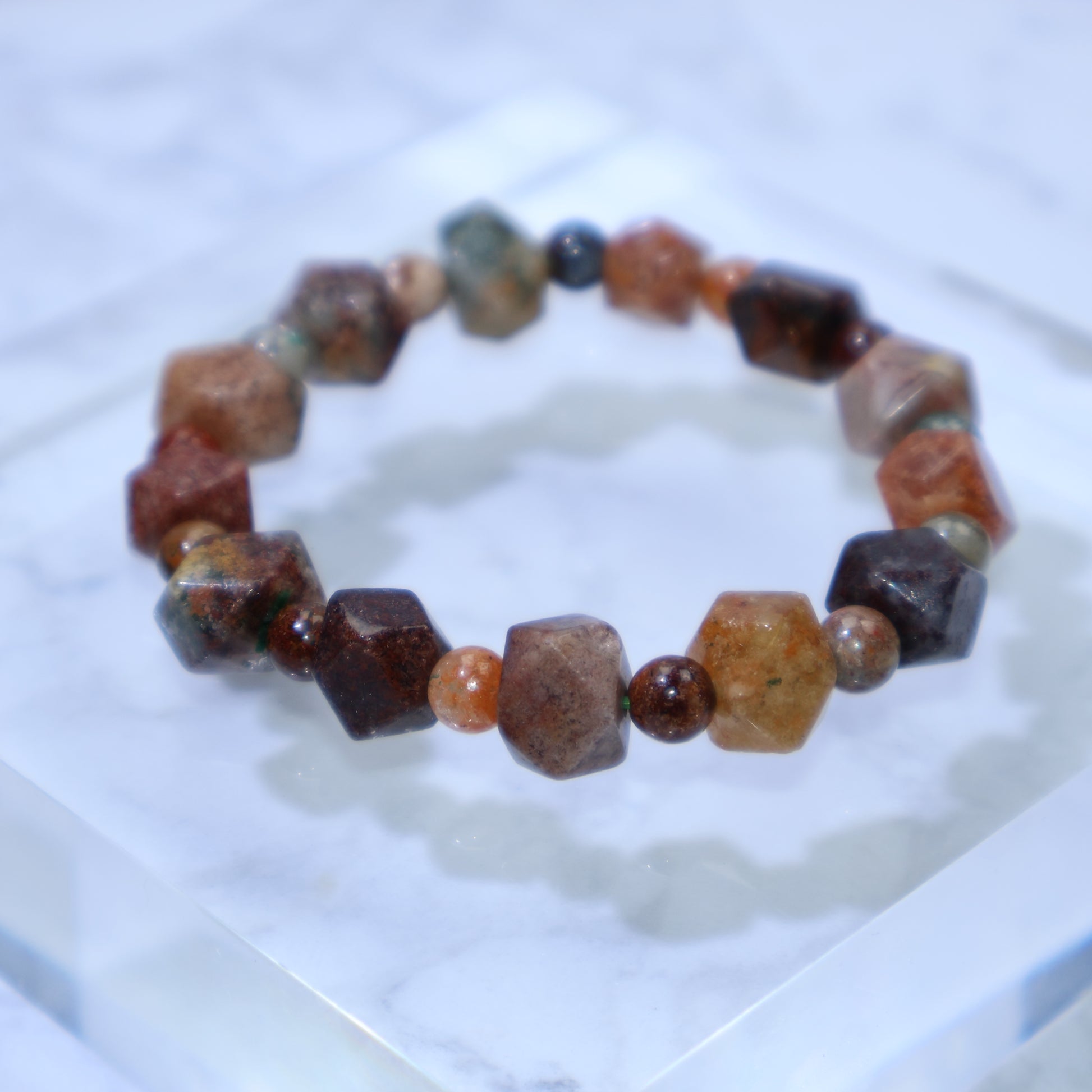 Top-down view of Multi-Phantom Quartz bracelet on clear acrylic block