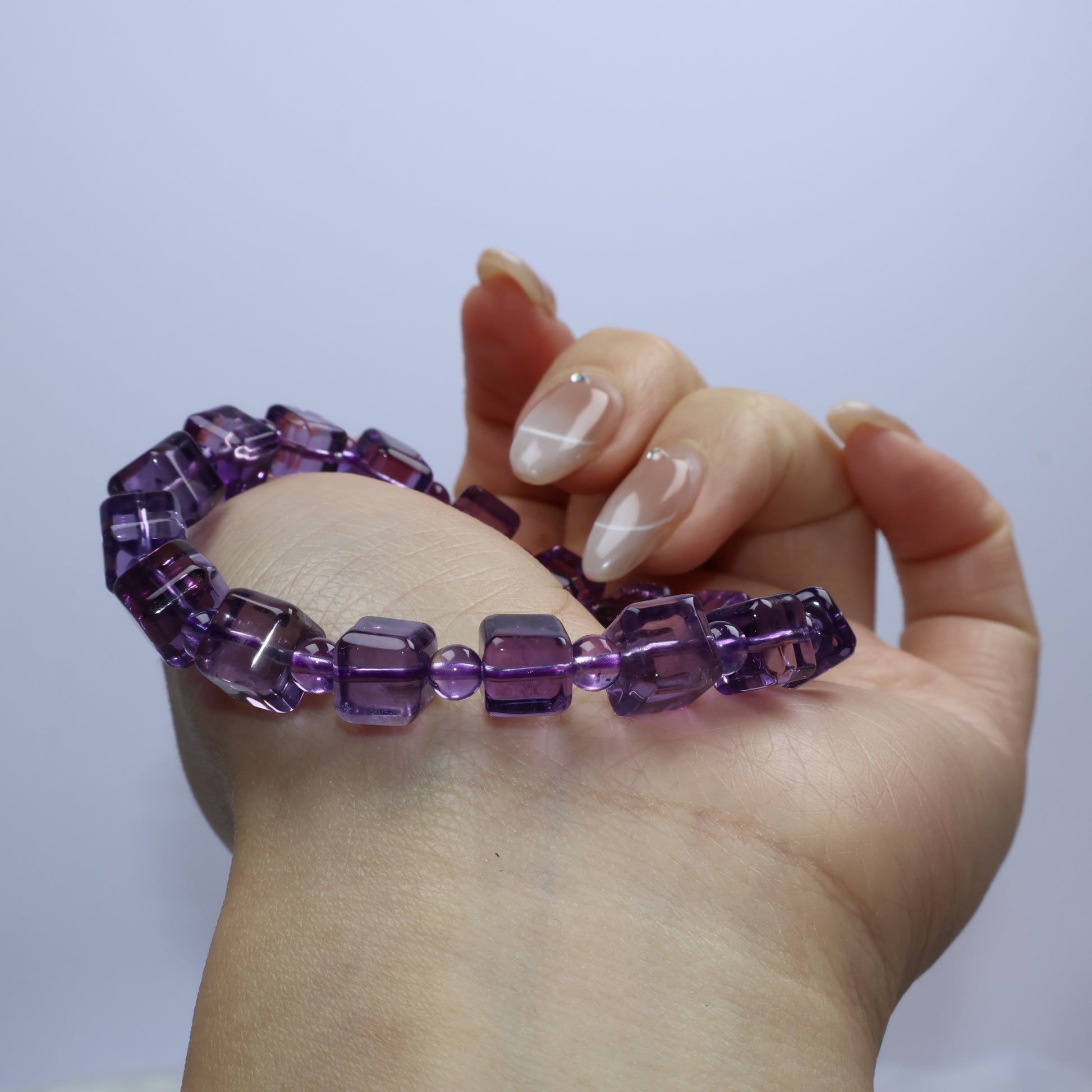 Angled shot emphasizing internal color banding within square Amethyst beads
