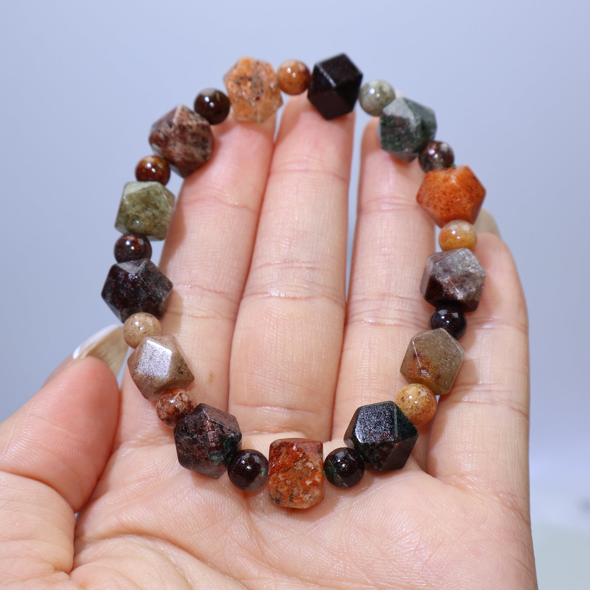 Handheld view of 11mm Multi-Phantom Quartz bracelet with full mineral inclusions