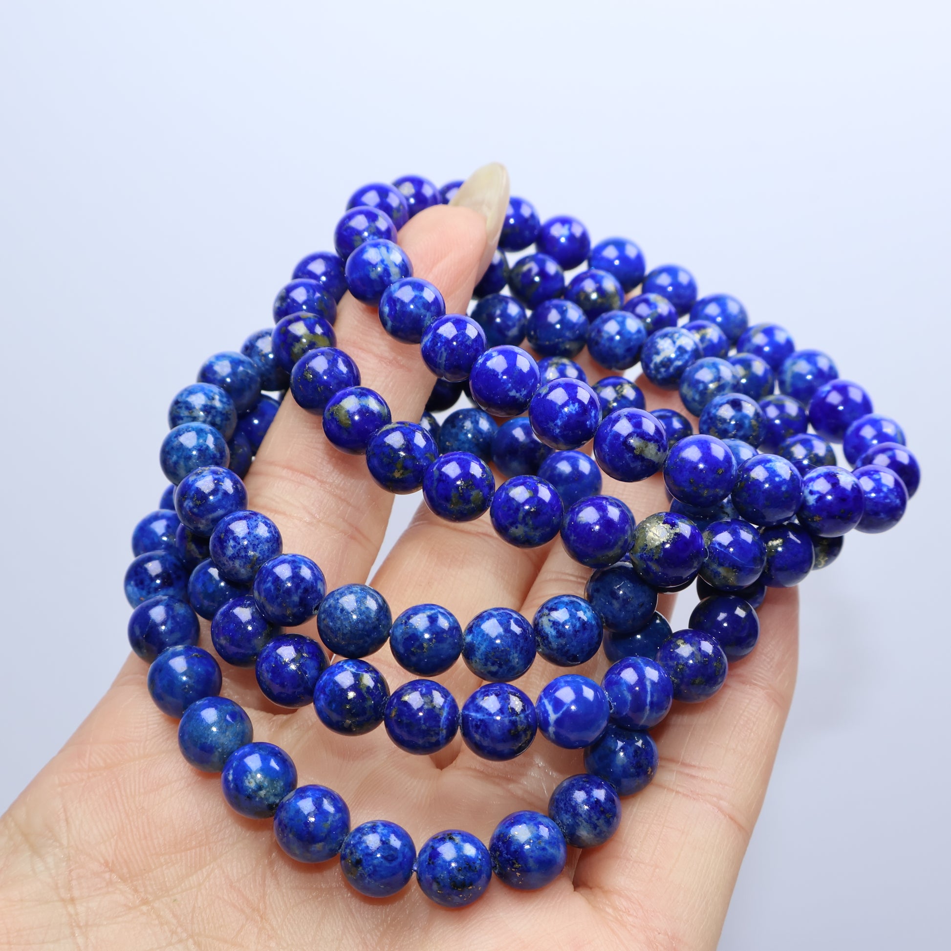 Close-up bunching of lapis bracelets with visible natural patterns