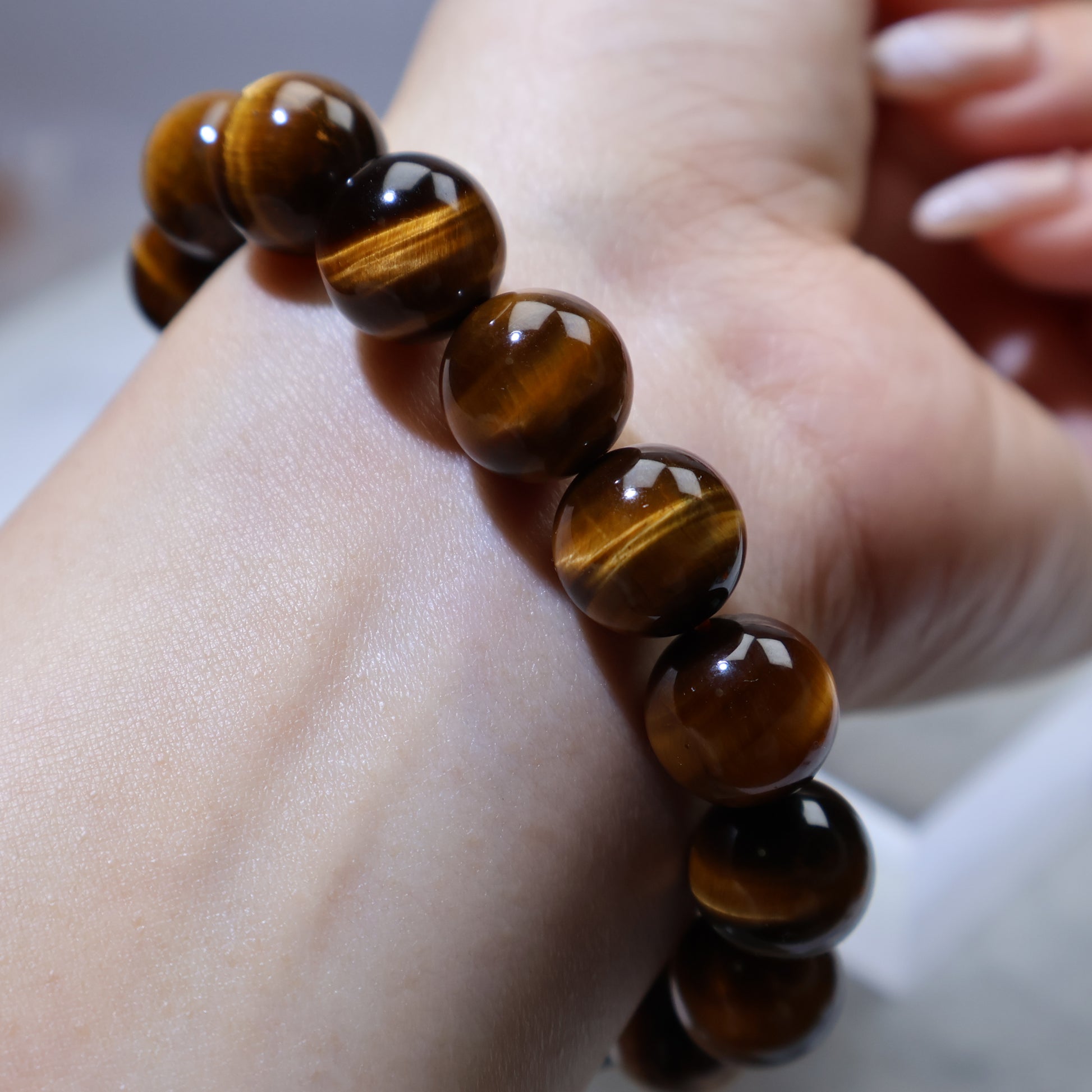Side wrist angle emphasizing golden stripes in each bead