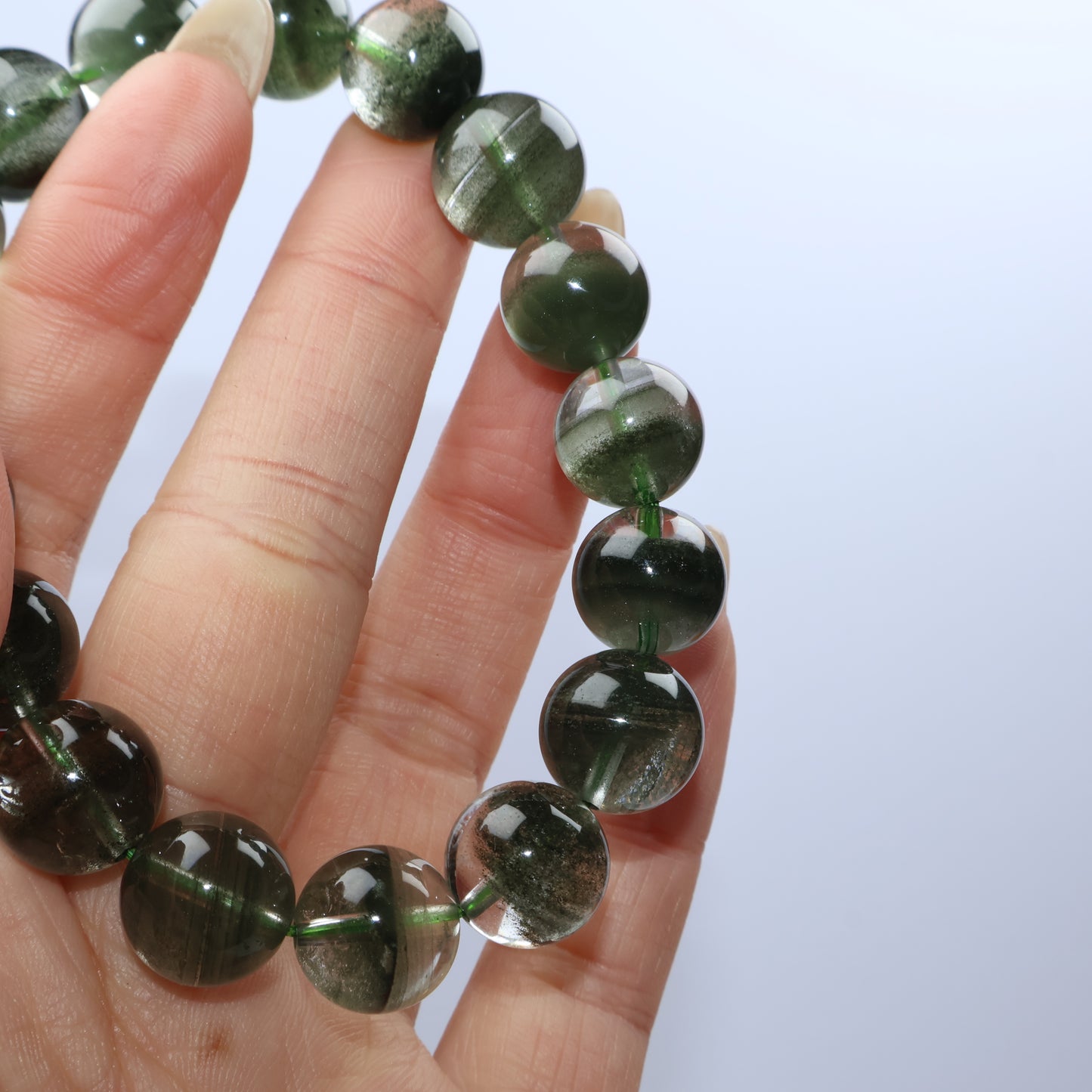 Detailed view of green phantoms inside individual quartz beads