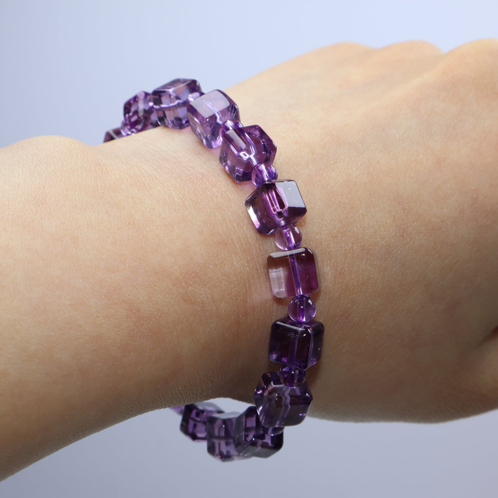 Bracelet draped across back of hand, highlighting crystal clarity and shine