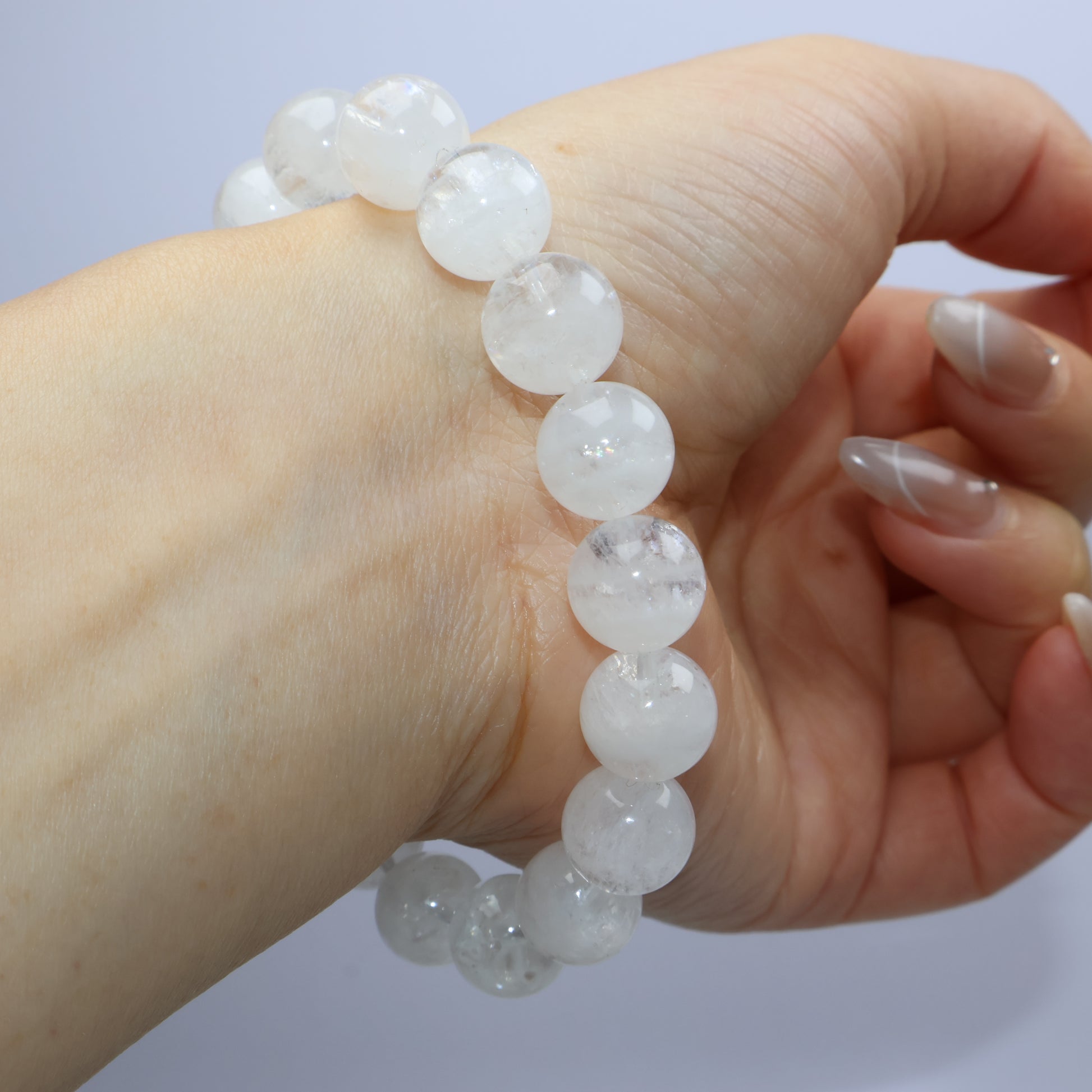 Bracelet wrapped on wrist from above, displaying bead alignment and translucency