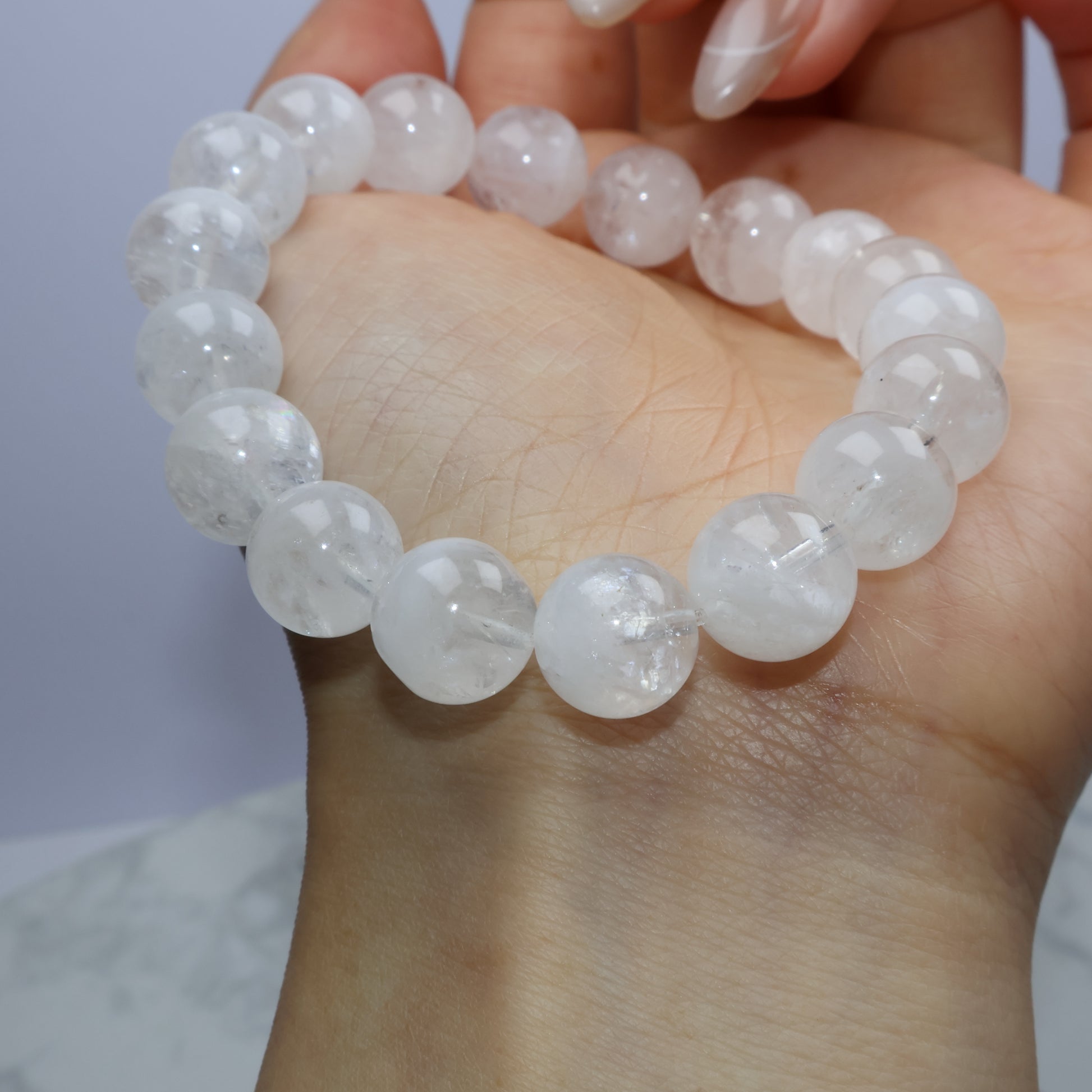 Top-down side angle with bracelet positioned on a clear block, showcasing high clarity