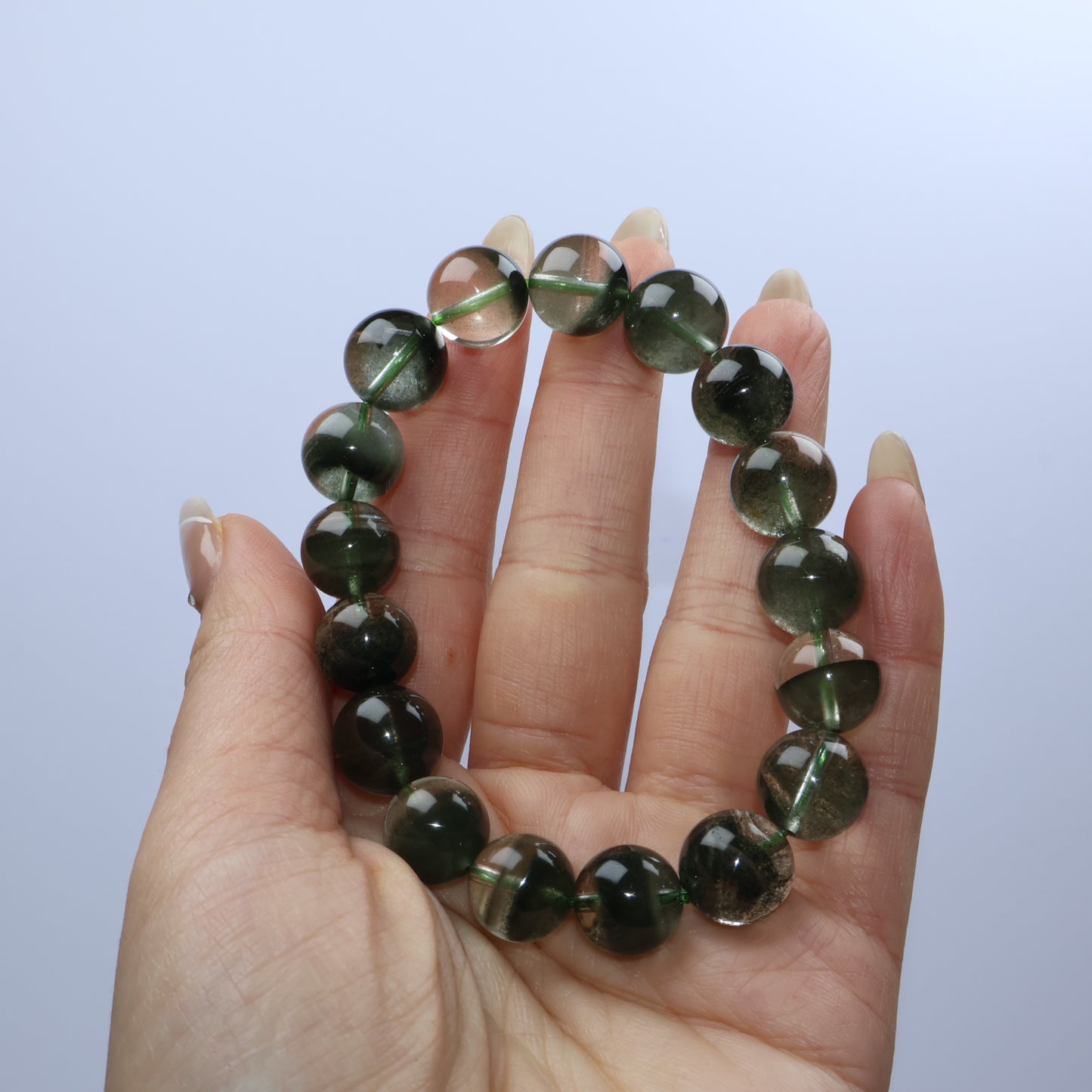 Handheld shot of the bracelet showing the gloss and translucency of the beads