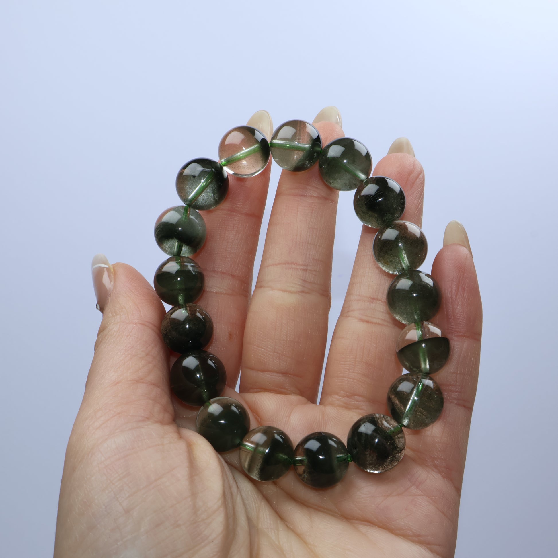 Handheld shot of the bracelet showing the gloss and translucency of the beads