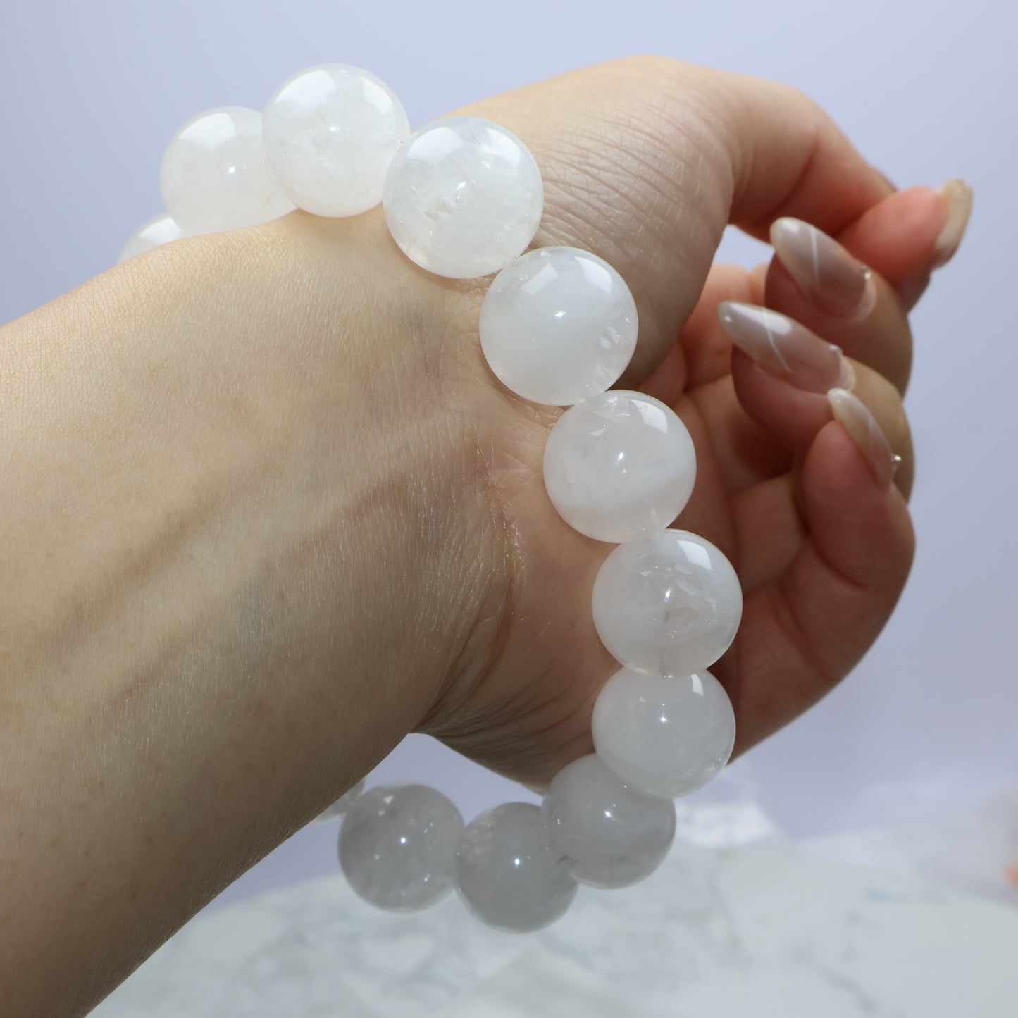 Side wrist angle holding bracelet up, showing full layout of round beads