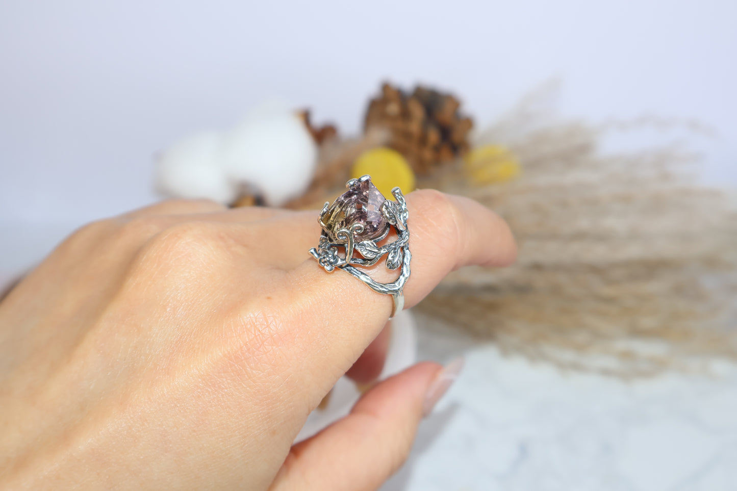 Side view of the floral ametrine ring worn on hand