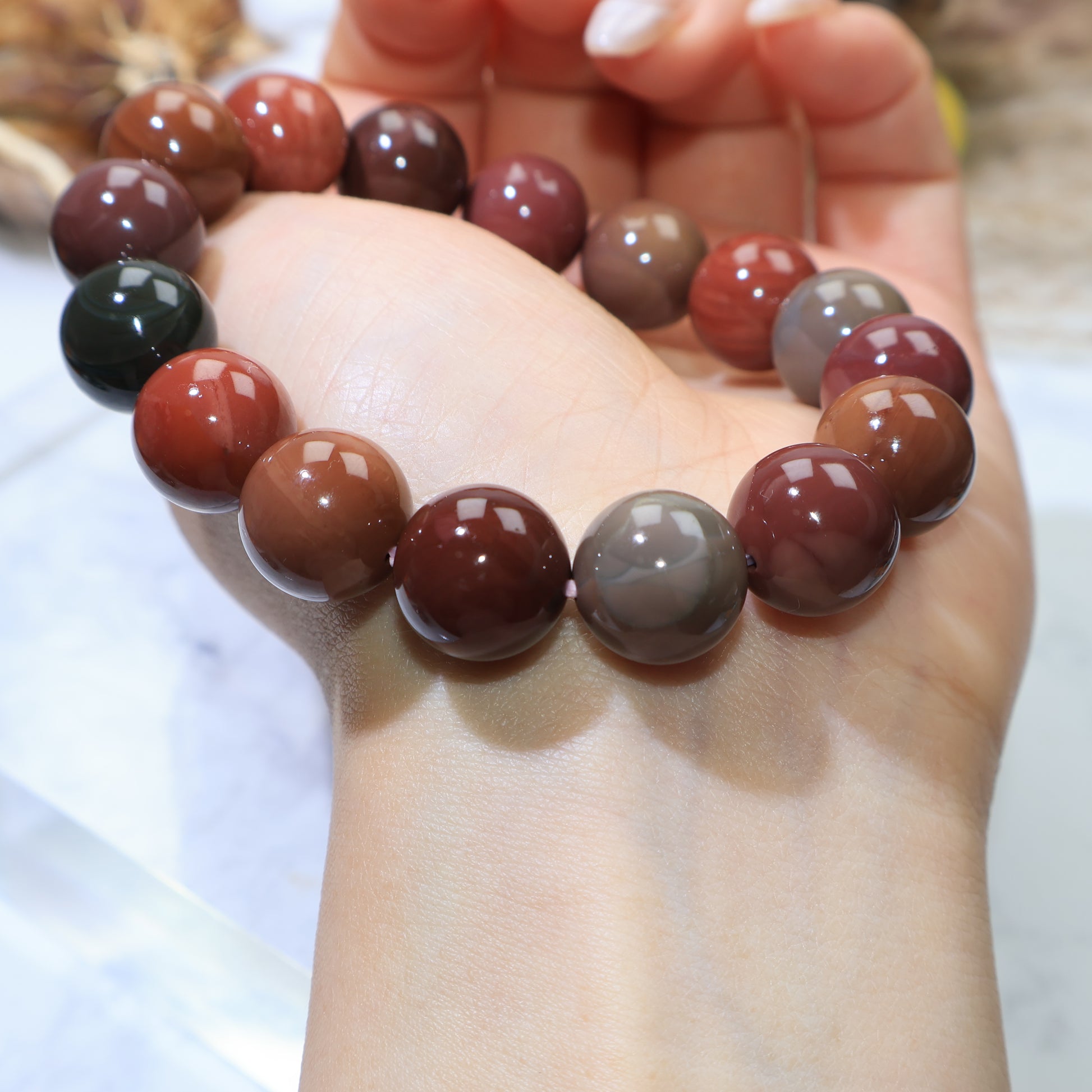 Close-up wrist view focusing on glossy surface and color variation of beads