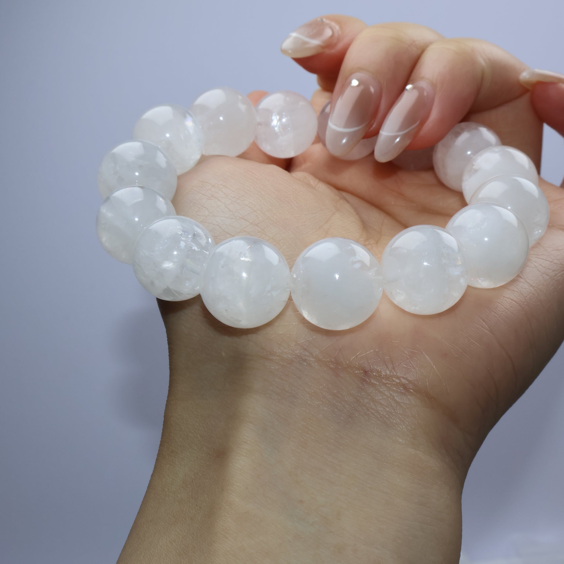Side angle of bracelet resting on wrist, emphasizing bead luster and texture
