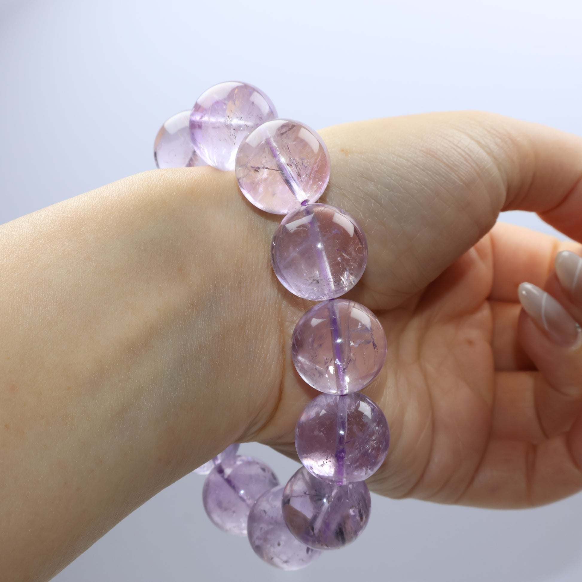 Light purple crystal bracelet with internal cracks and cloudy textures