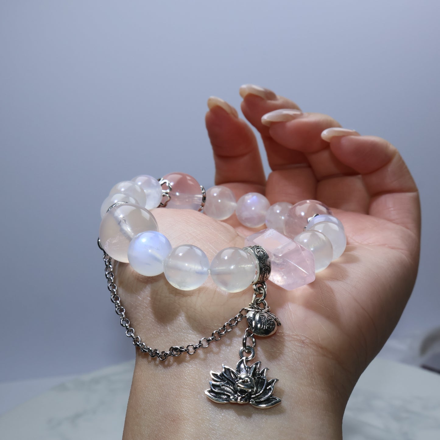 Close-up of rose quartz fox pendant on the bracelet