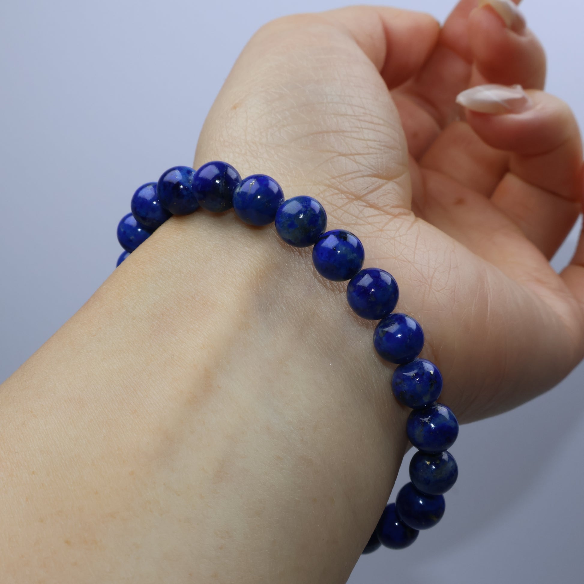 Wrist-wearing view of the 7mm lapis bracelet on a 15cm wrist