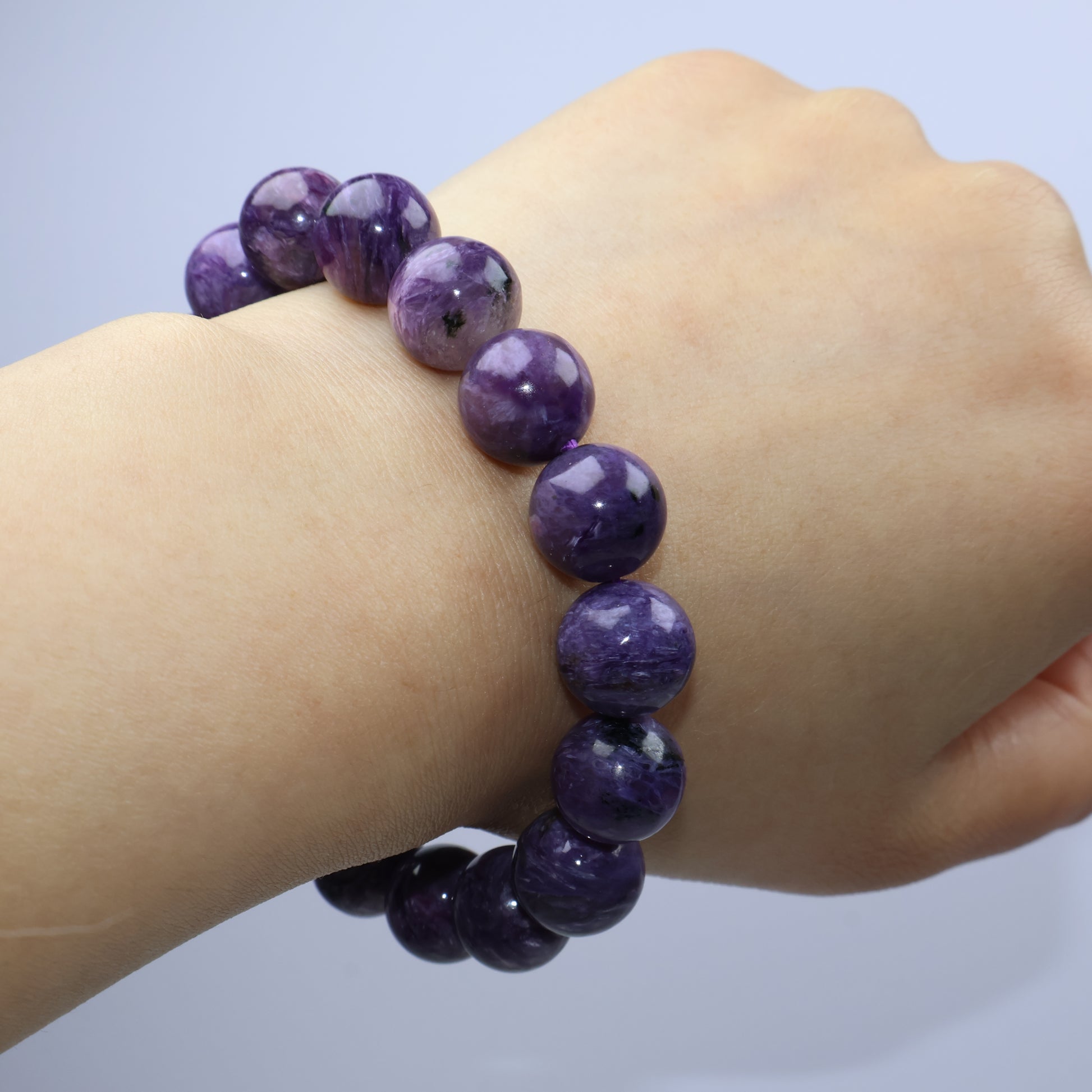 Worn on wrist – deep purple Charoite beads with vivid natural variation