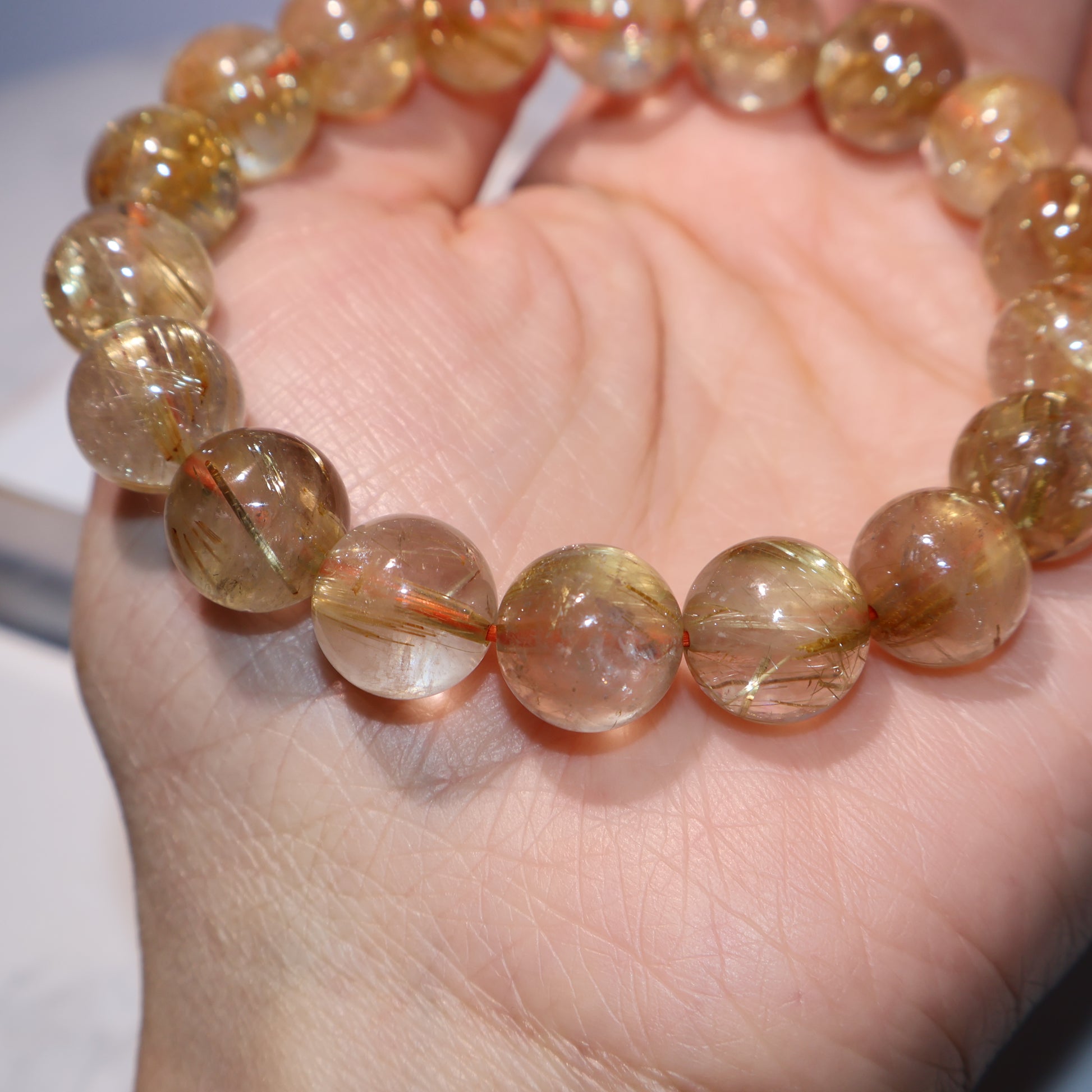 Zoomed-in detail of natural rutile threads inside clear quartz beads