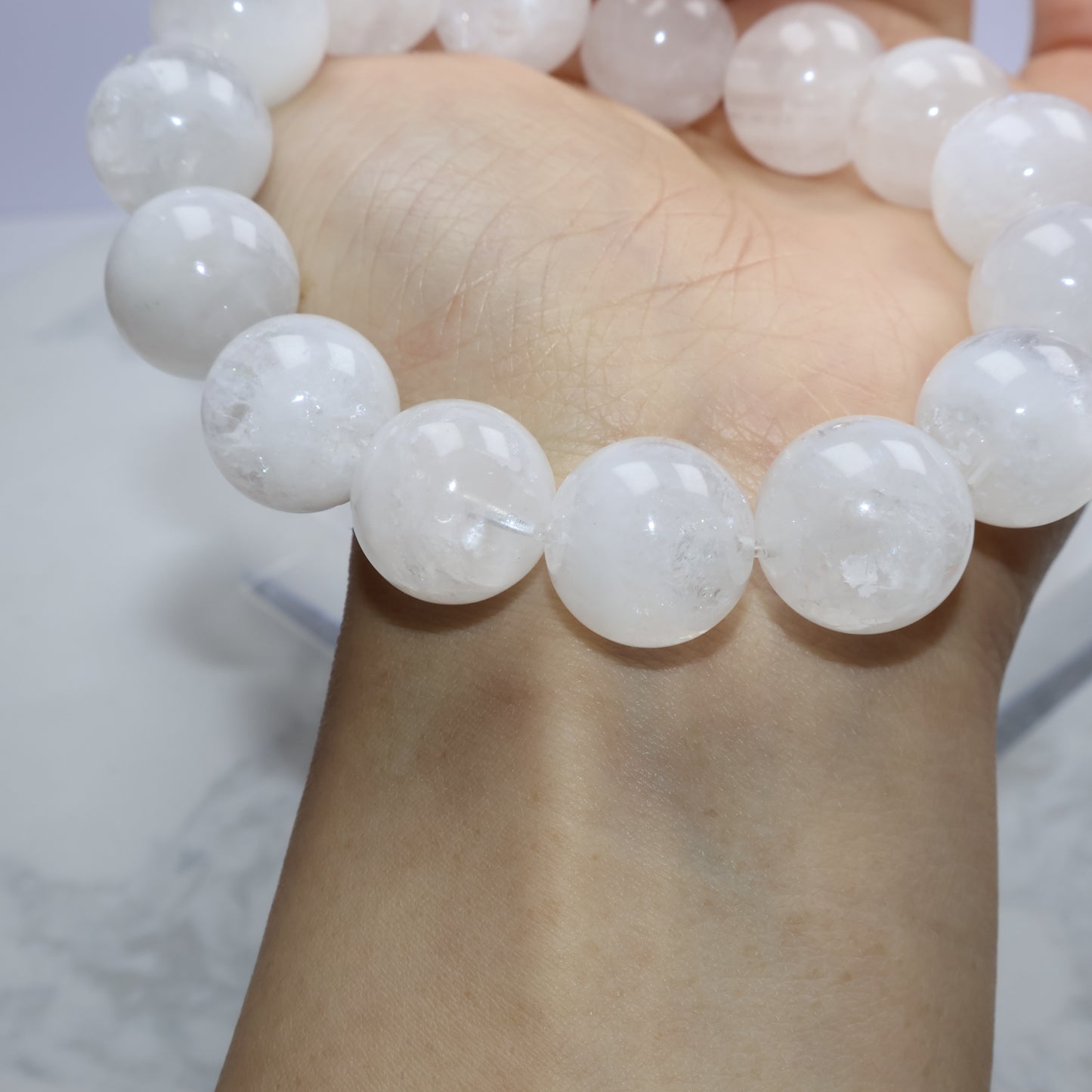 Wrist view highlighting natural inclusions and matte-like inner texture of White Phantom Quartz