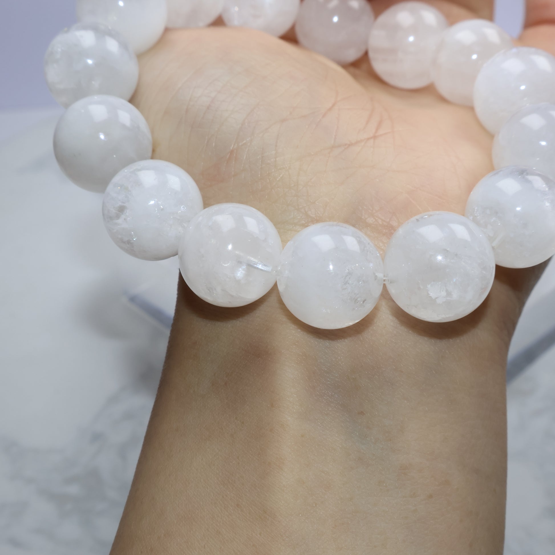 Wrist view highlighting natural inclusions and matte-like inner texture of White Phantom Quartz