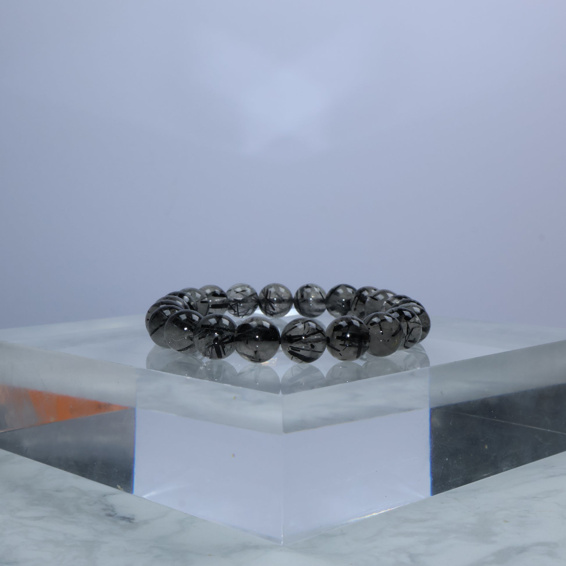 Side angle showing thick black rutile inclusions in 8mm beads