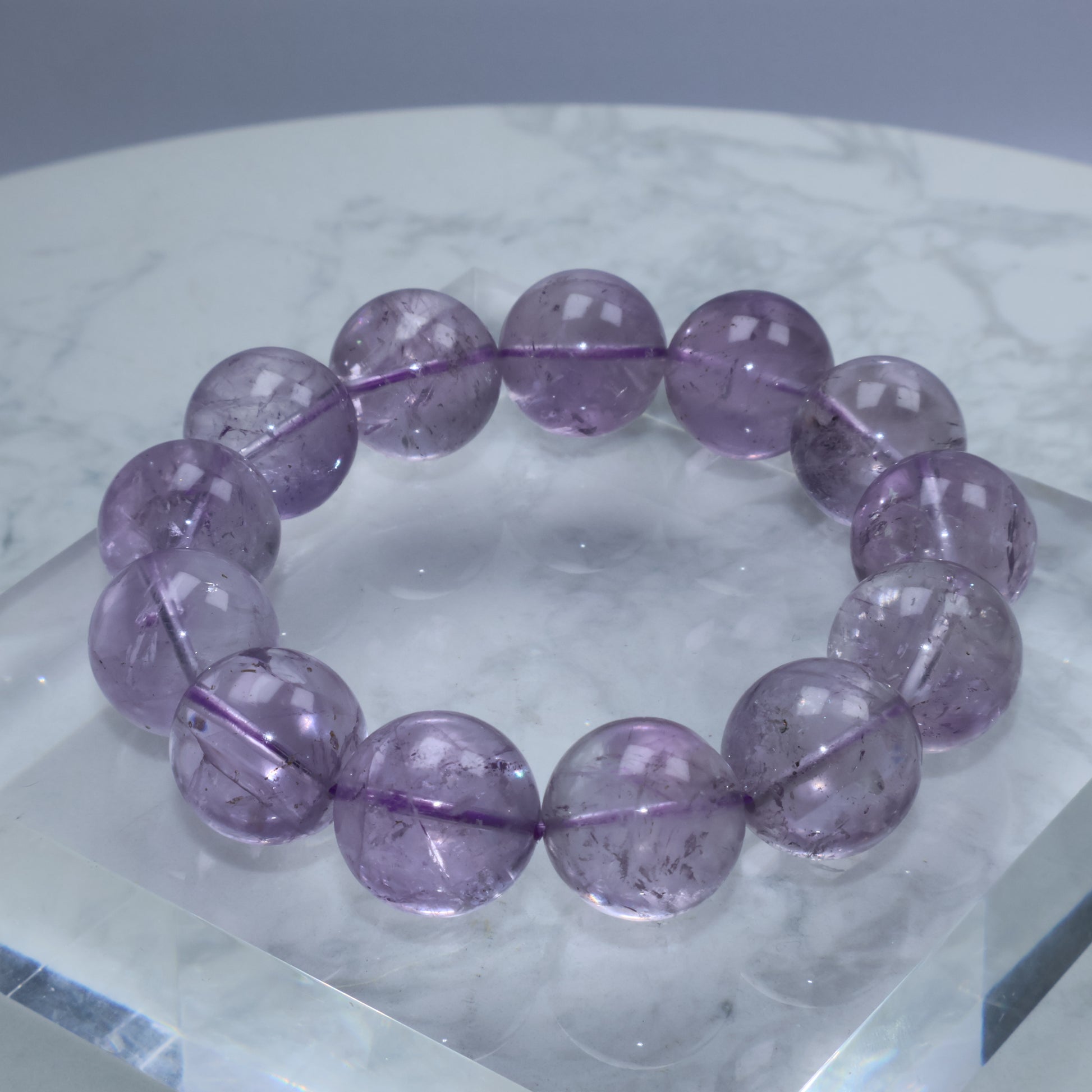 Close-up of 17mm frosted amethyst bracelet with visible internal textures