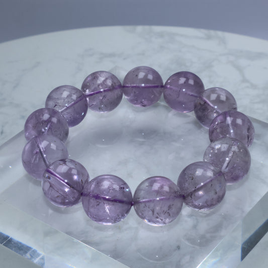 Close-up of 17mm frosted amethyst bracelet with visible internal textures