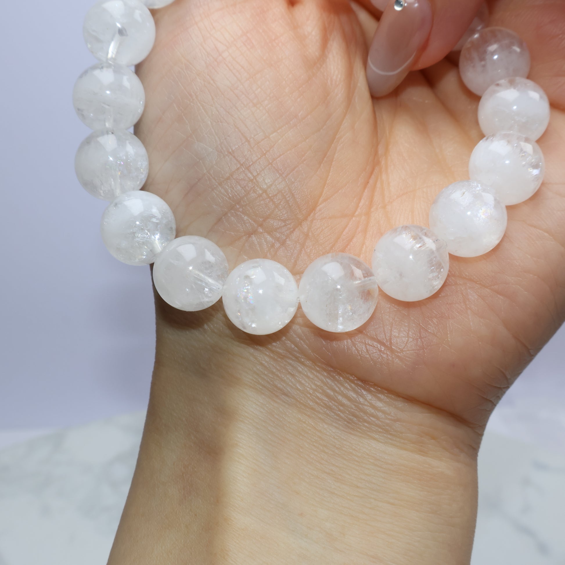 Angled wrist shot showing bead reflections and delicate inner patterns