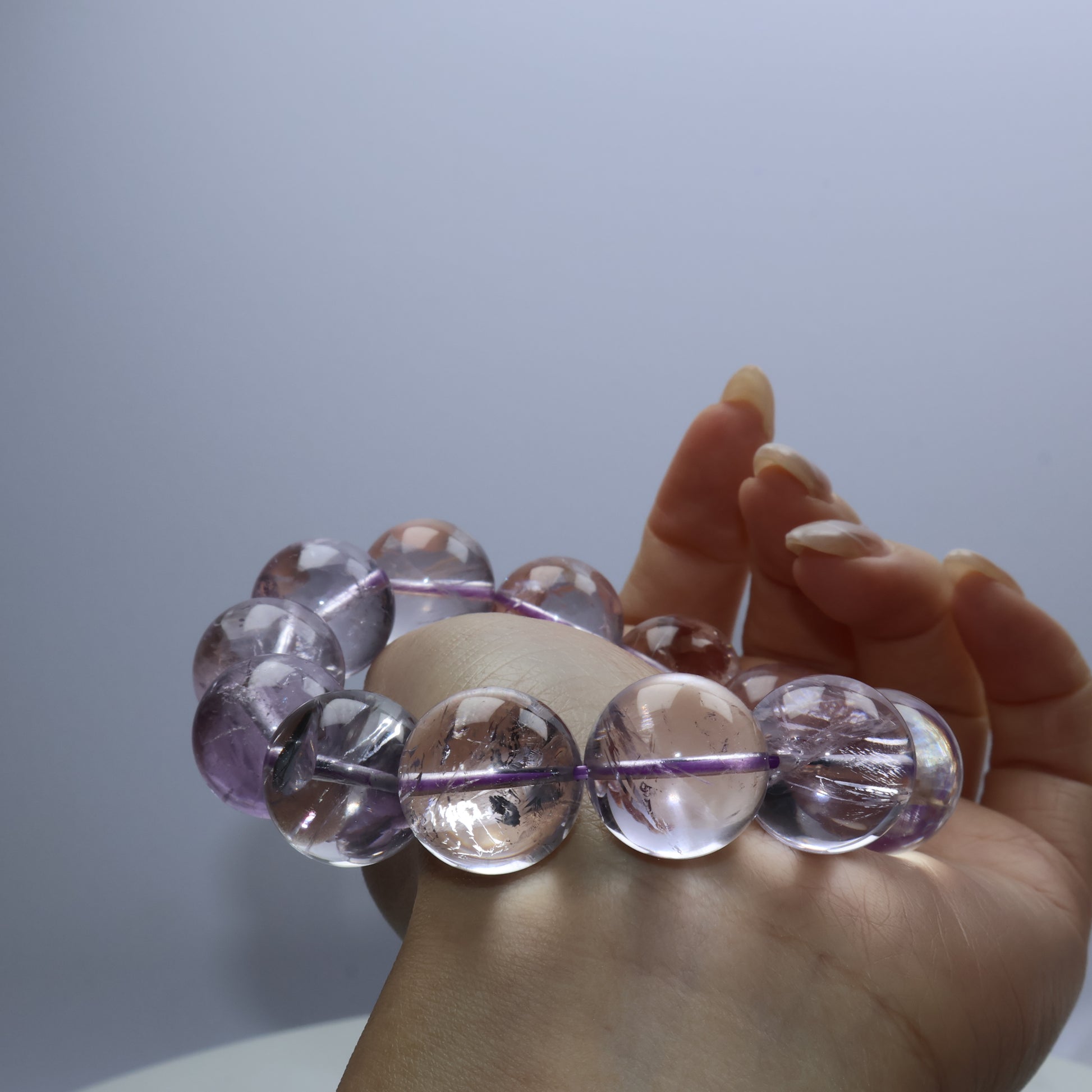 Side view of amethyst bracelet showing natural inclusions