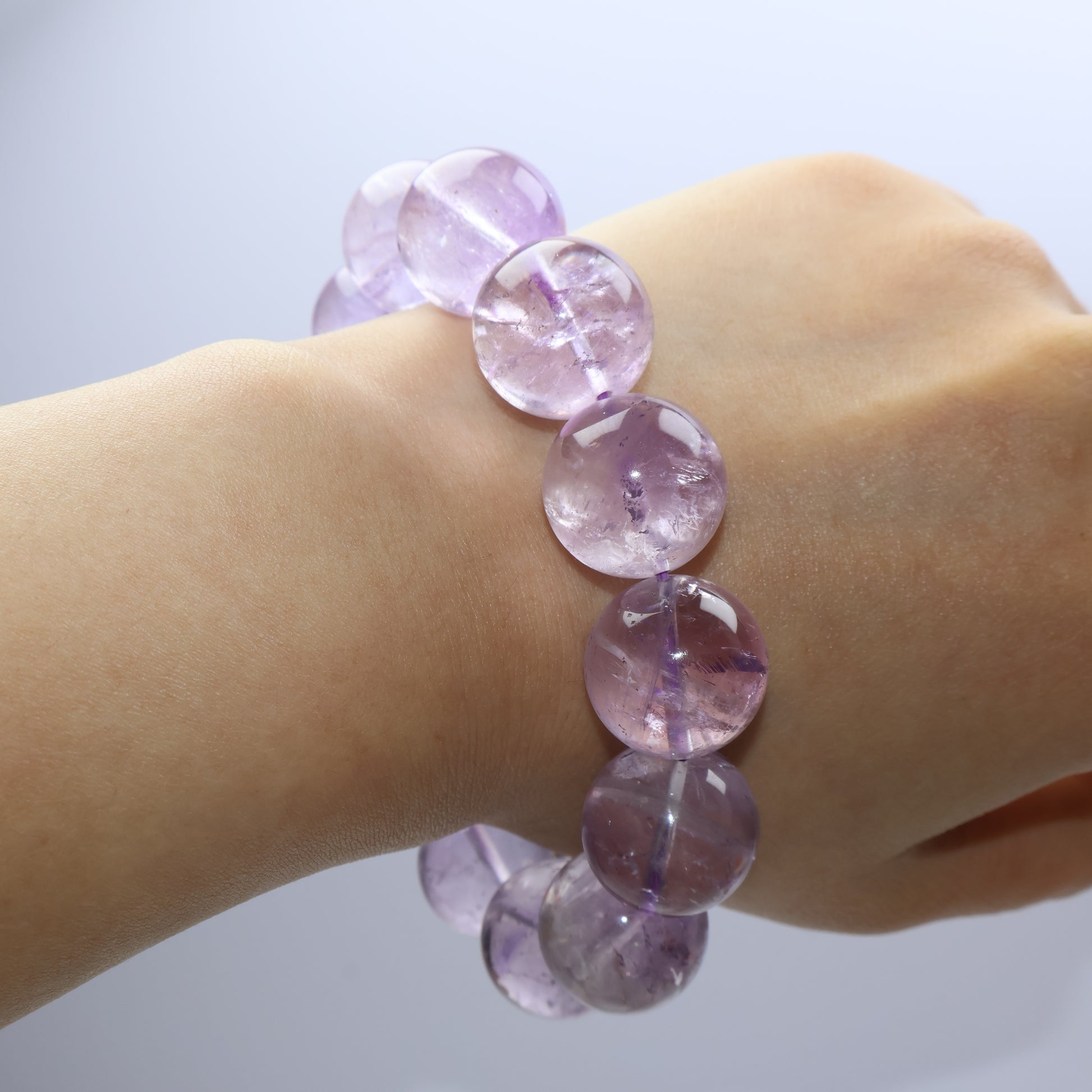 Frosted amethyst bracelet worn on wrist, showing natural clarity variations