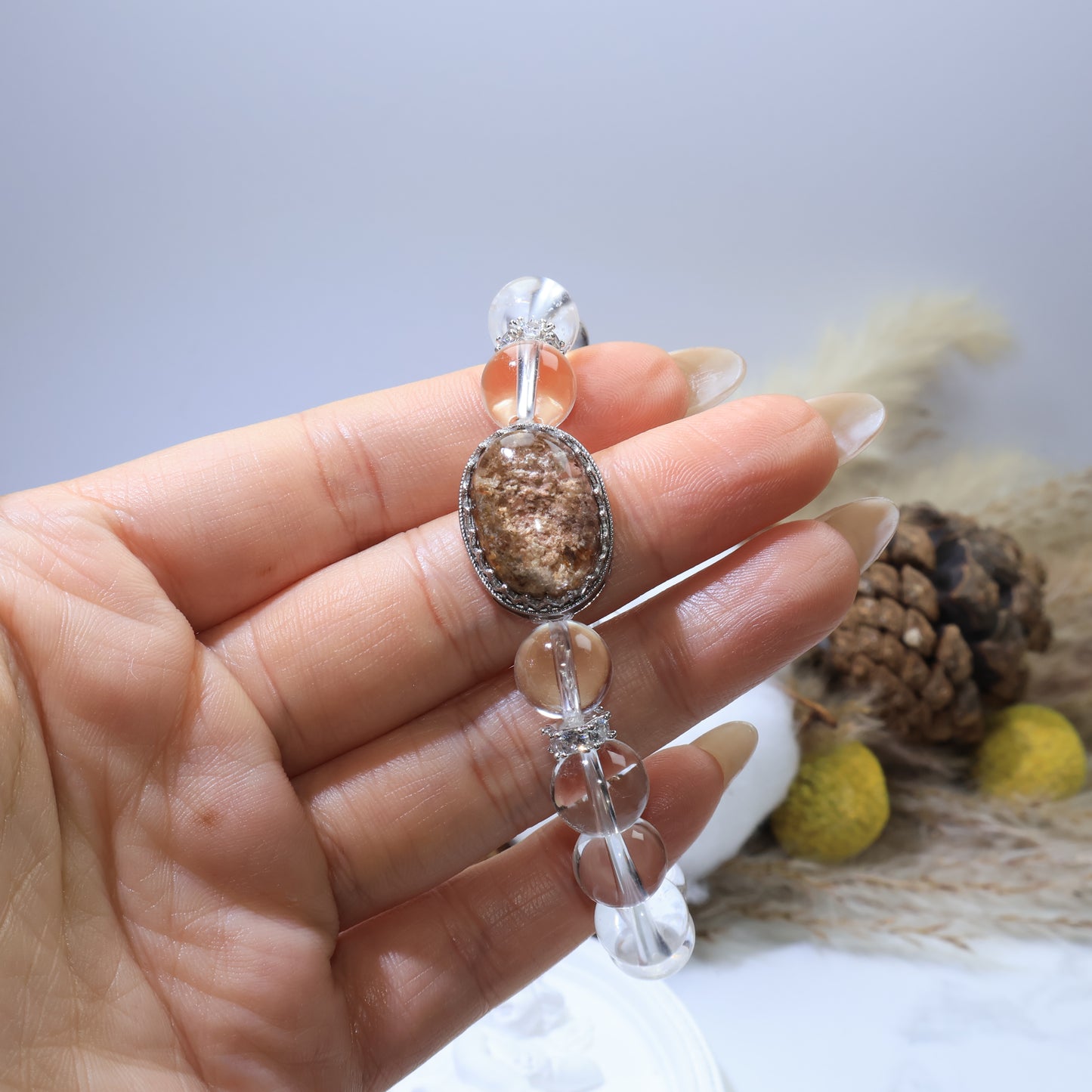 Handheld view of Phantom Quartz bracelet showing clarity of 10mm clear quartz beads