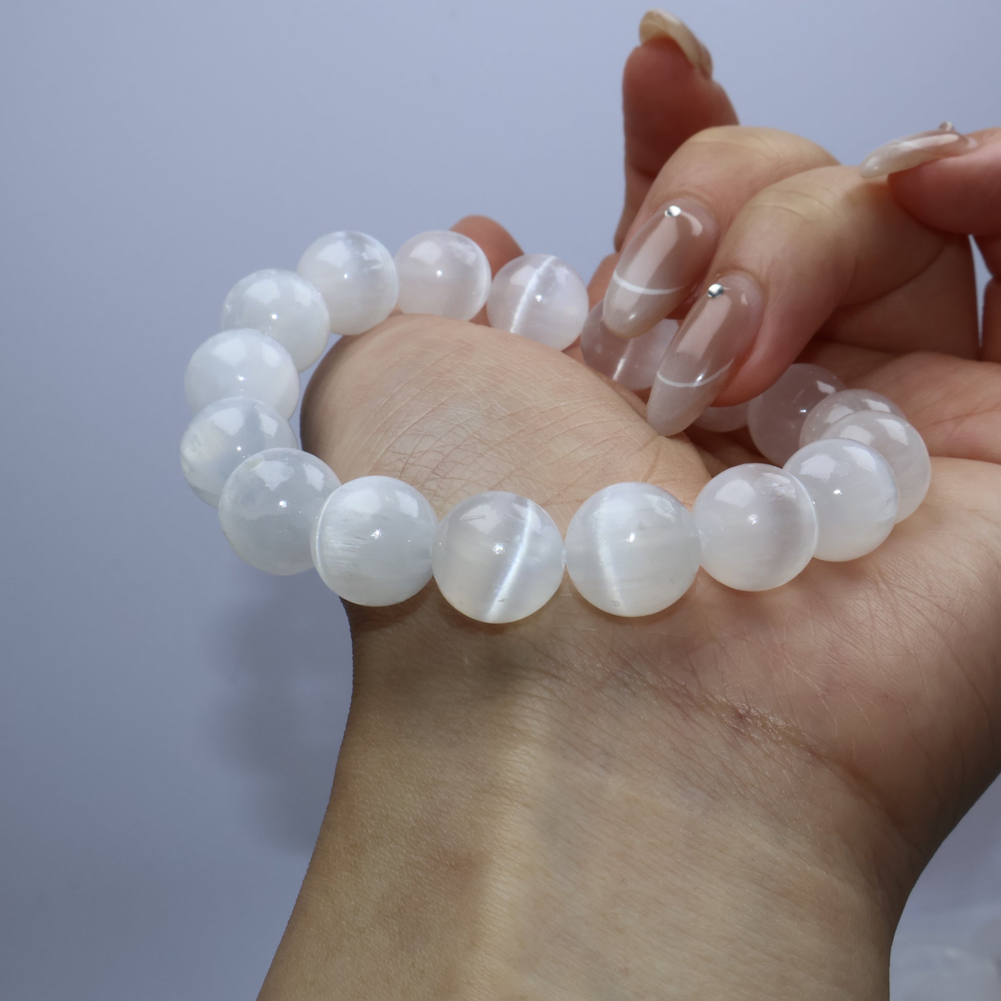 Side view of bracelet on palm, highlighting the transparency and light play